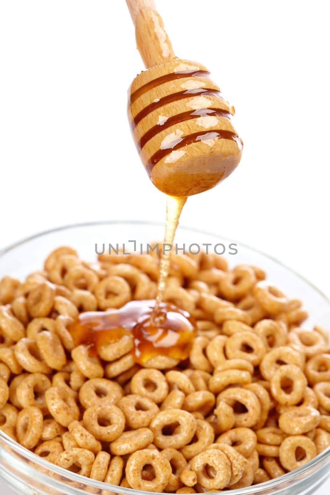 Pouring honey on cornflakes