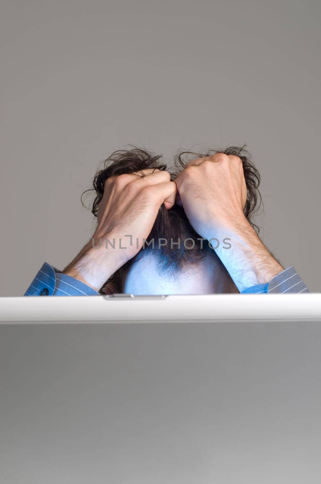 man looking at computer in desperation