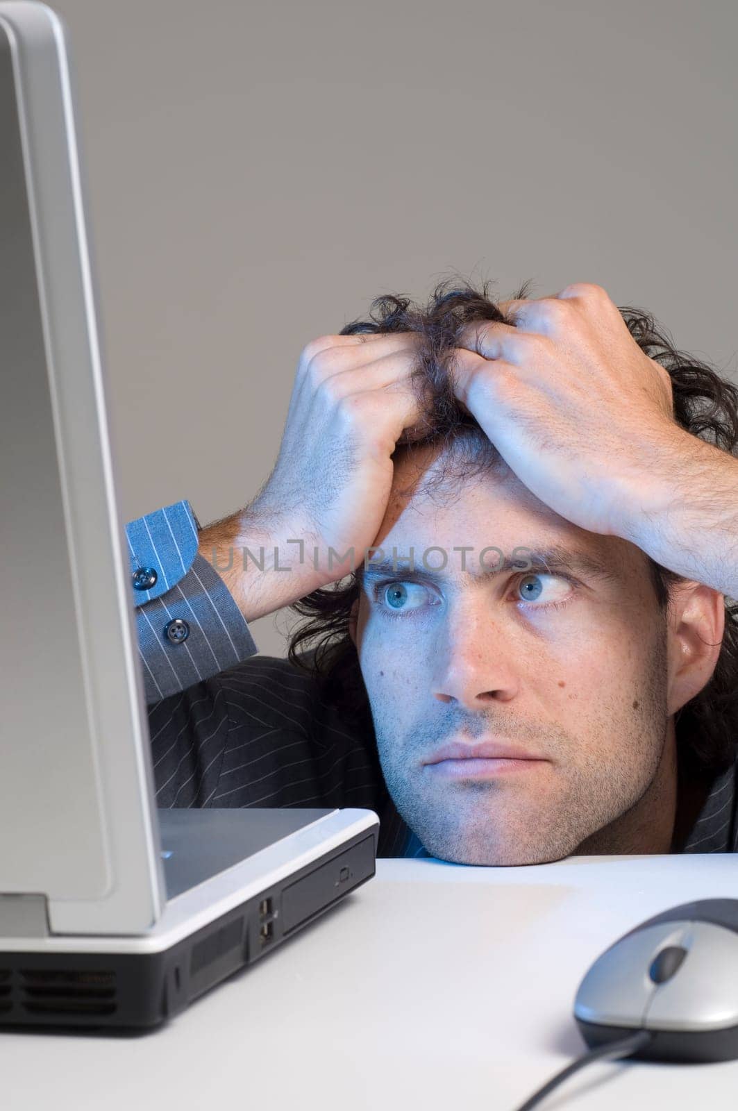 man looking at computer in desperation