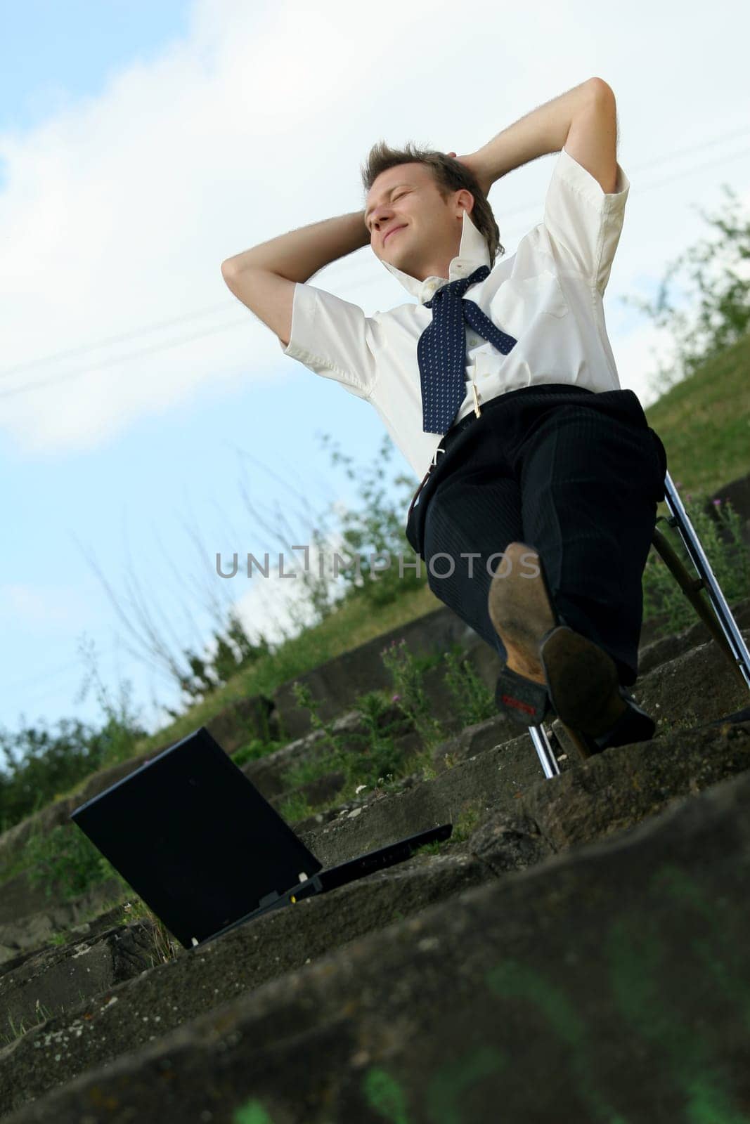 relaxing businessman outdoors