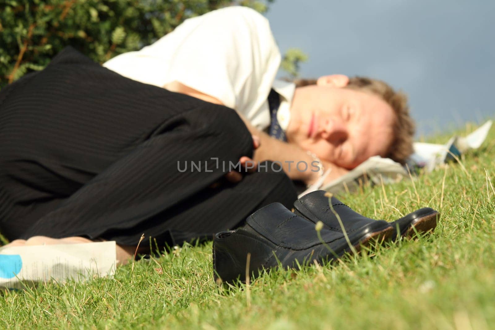 businessman sleeping in park