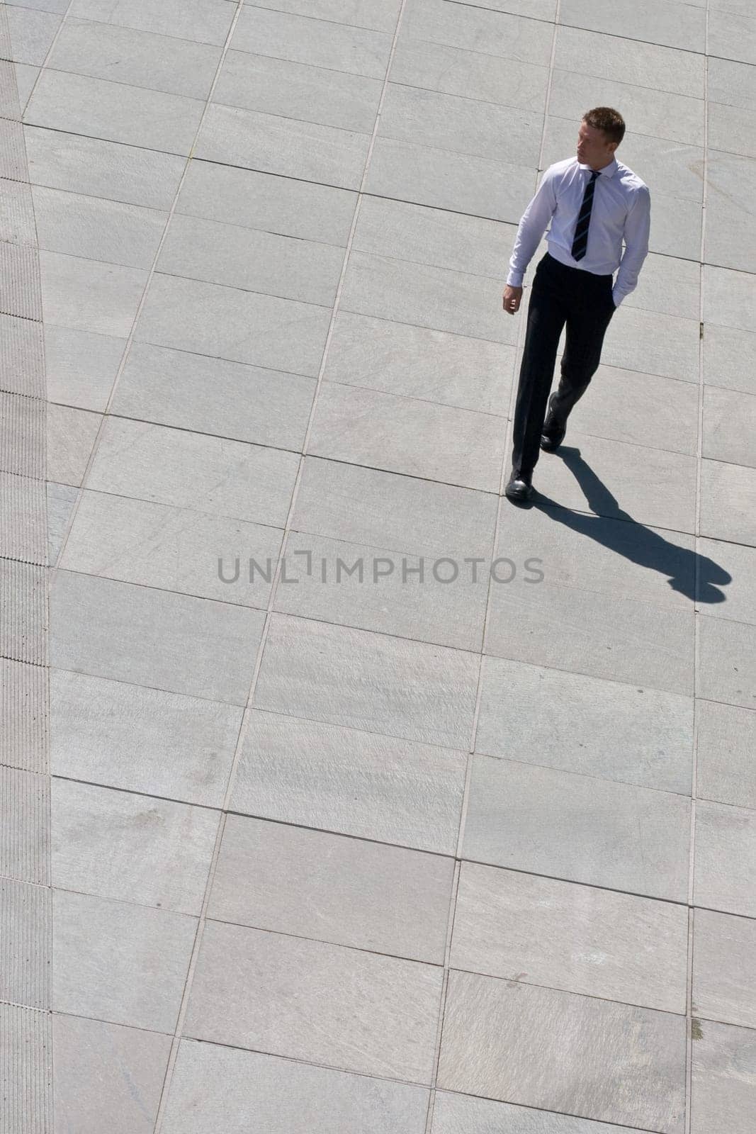 Corporate Man Walking On Pavement