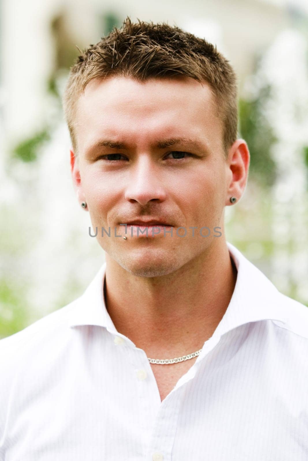 Portrait Of A Handsome Man With Piercing Earrings