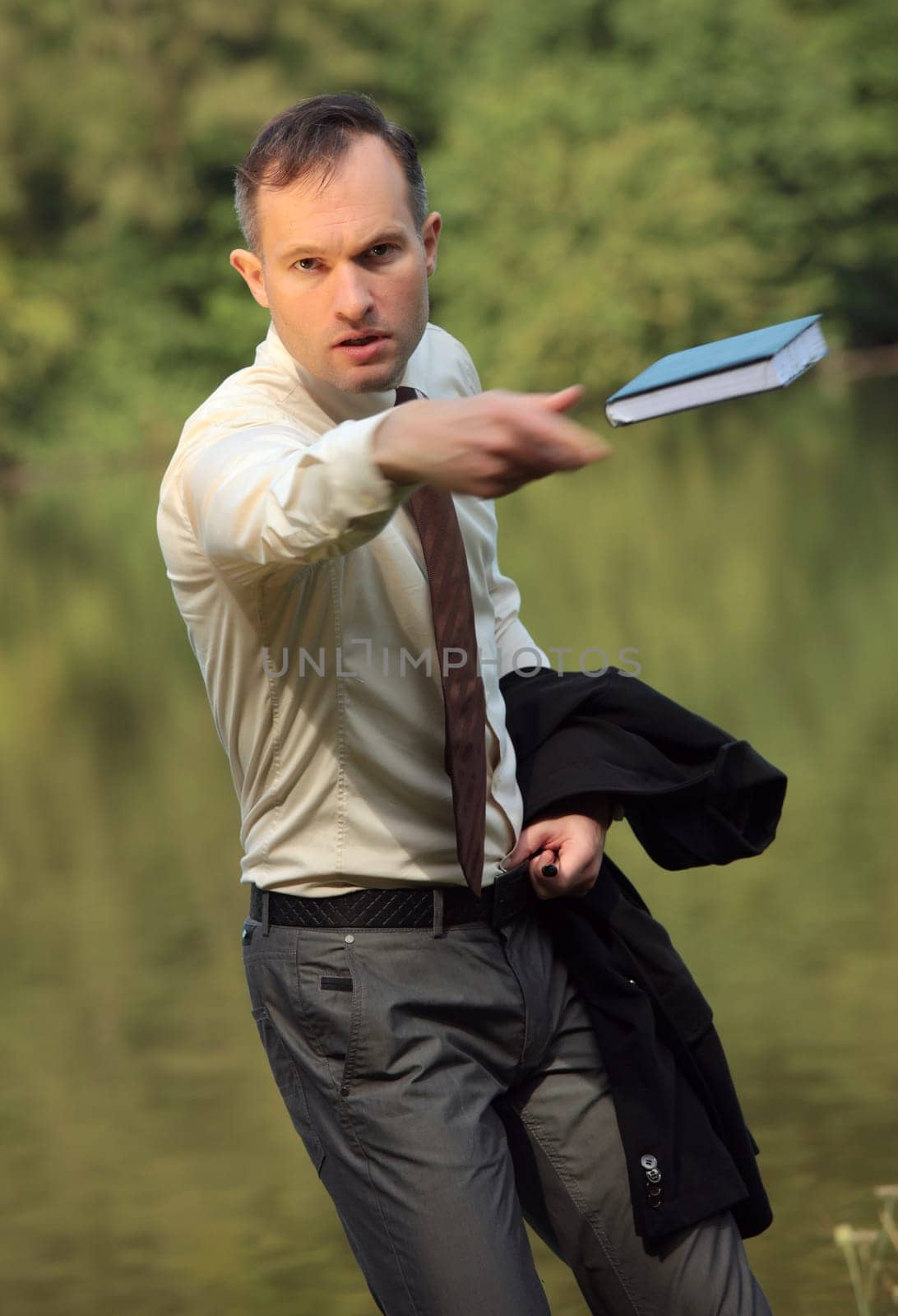 man throwing a book