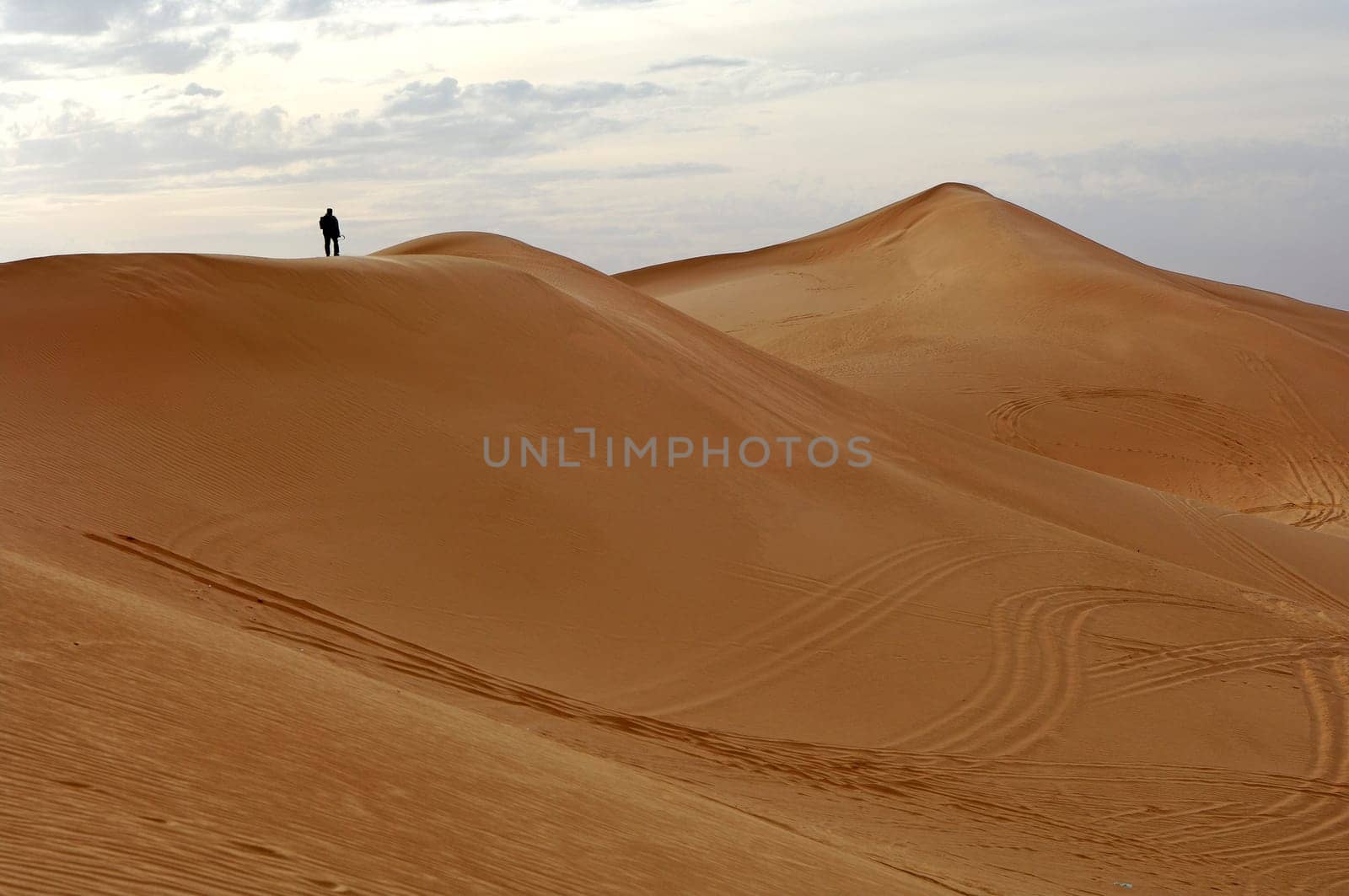 Tourist climbing a sand dune,Libyan desert,Sahara desert,Libya