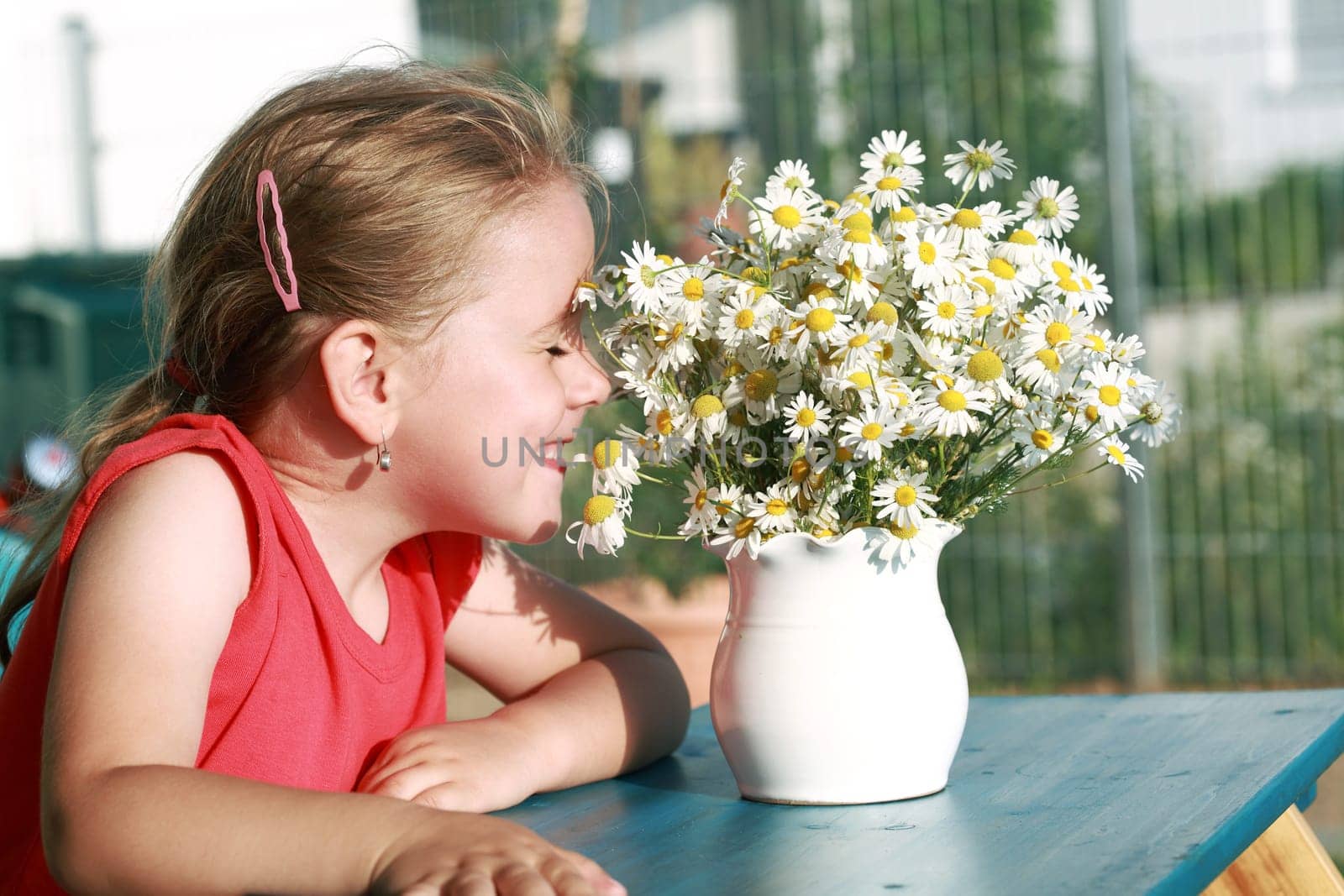 Little girl with chamomile