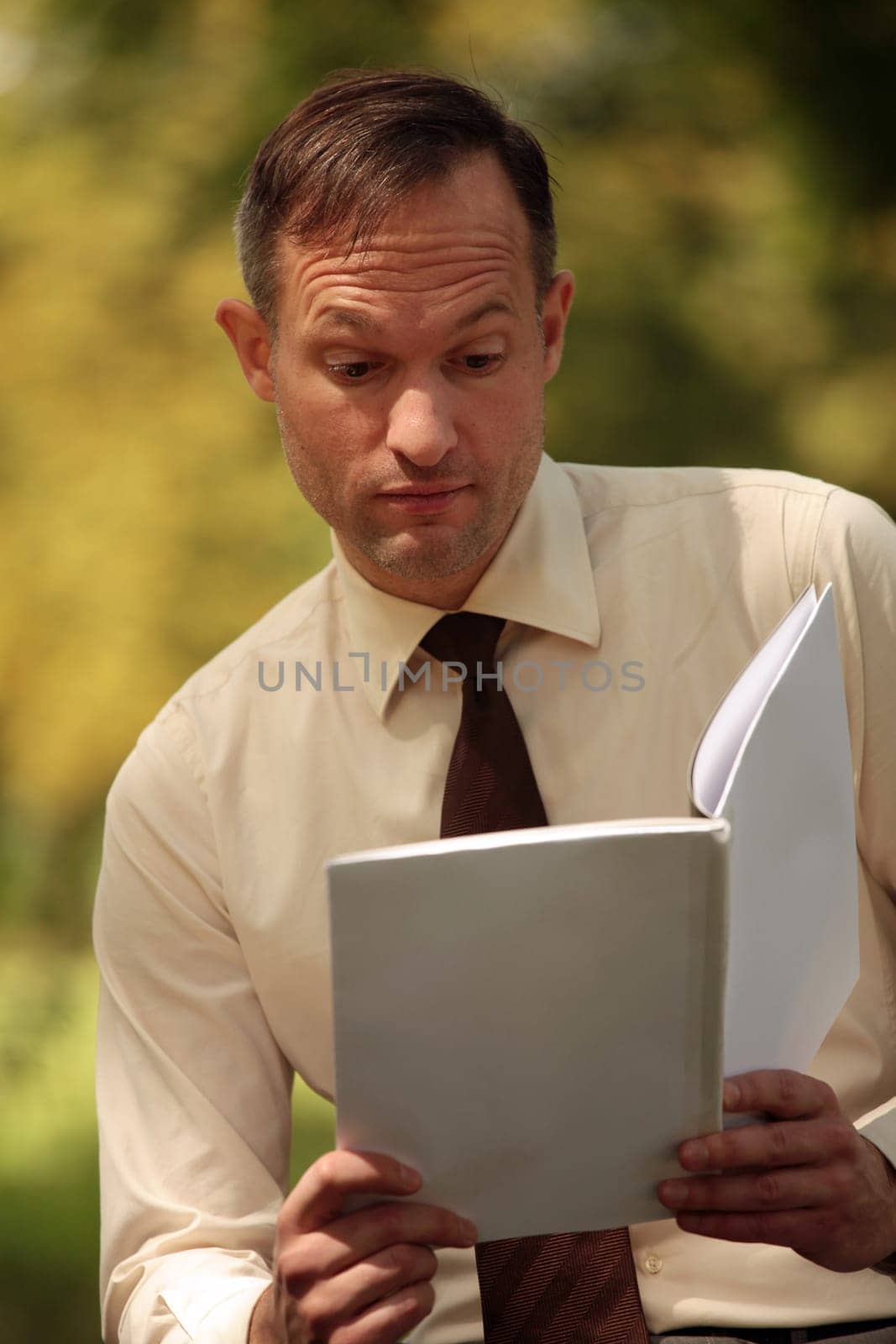 reading magazine in park