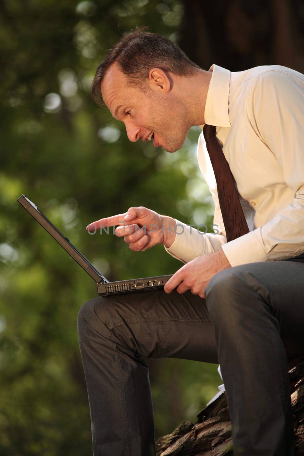 pointing with finger at laptop