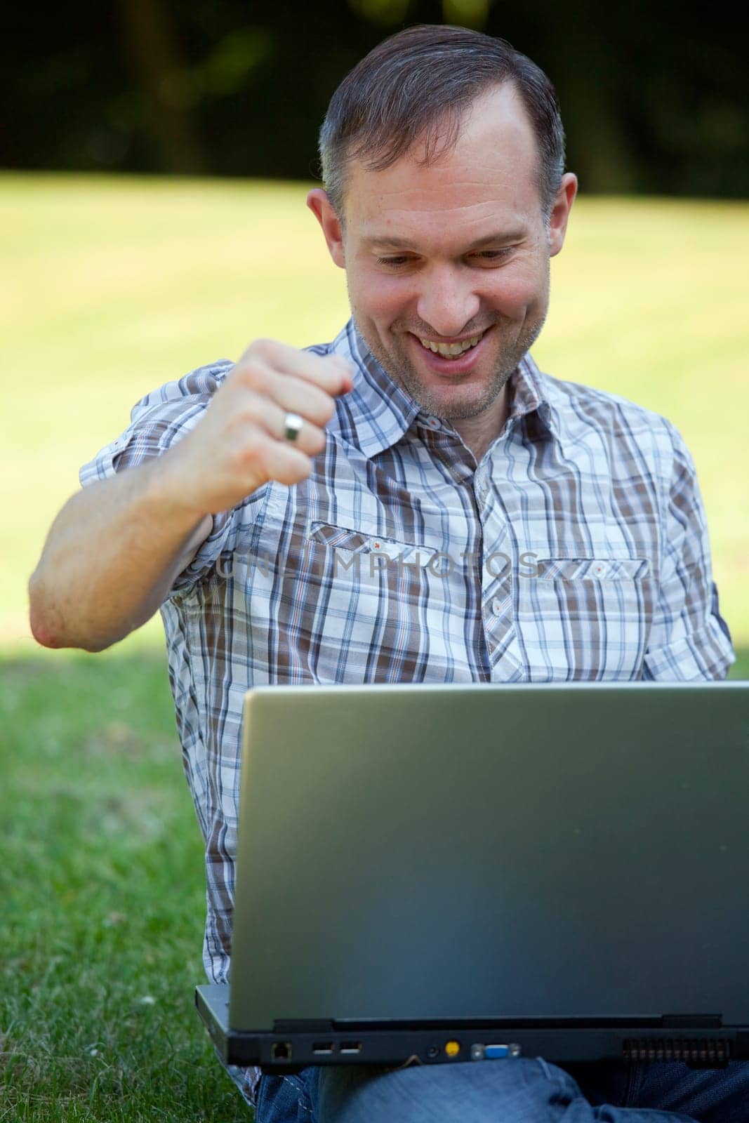 happy man with laptop outdoor