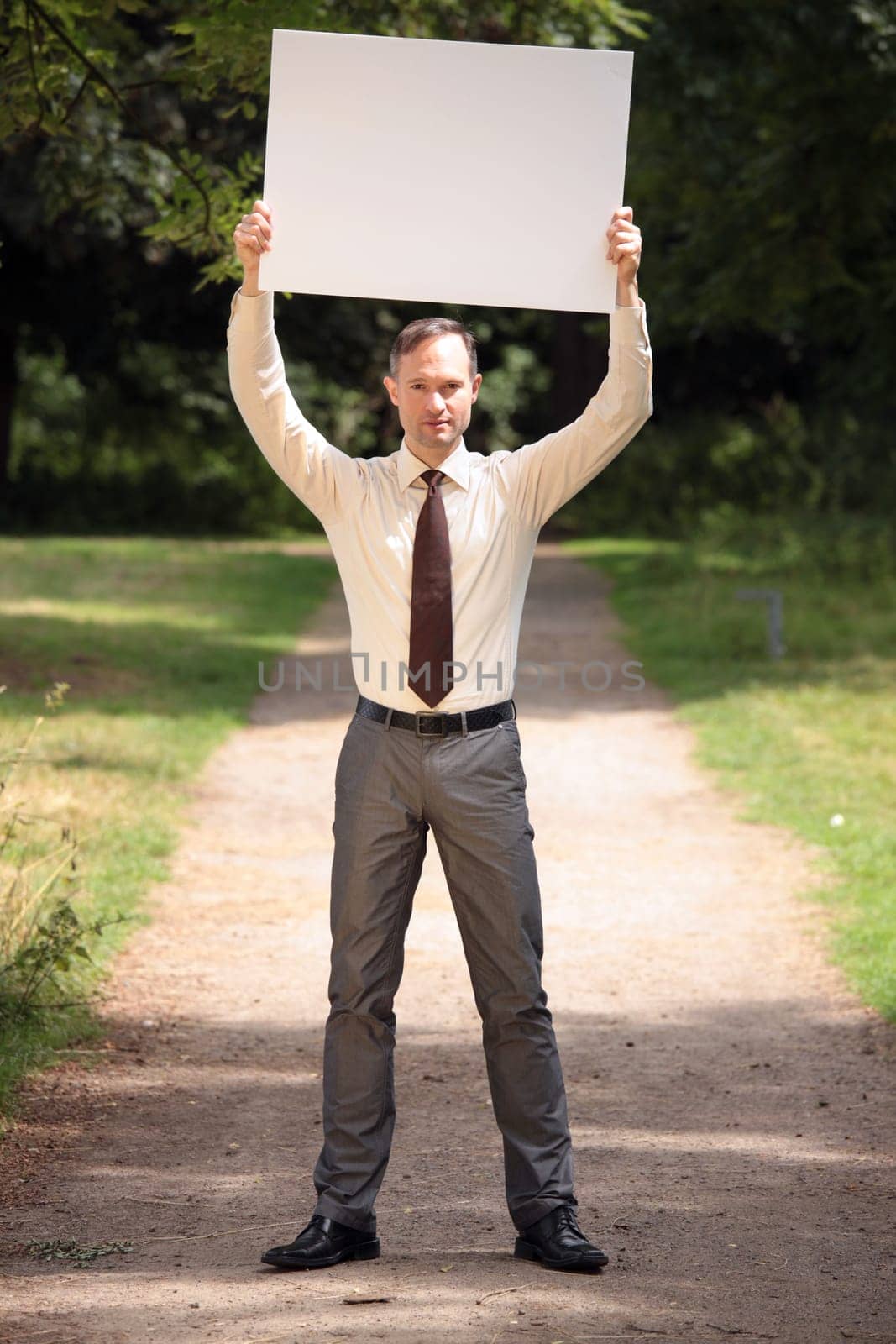 man holding blank bulletin board