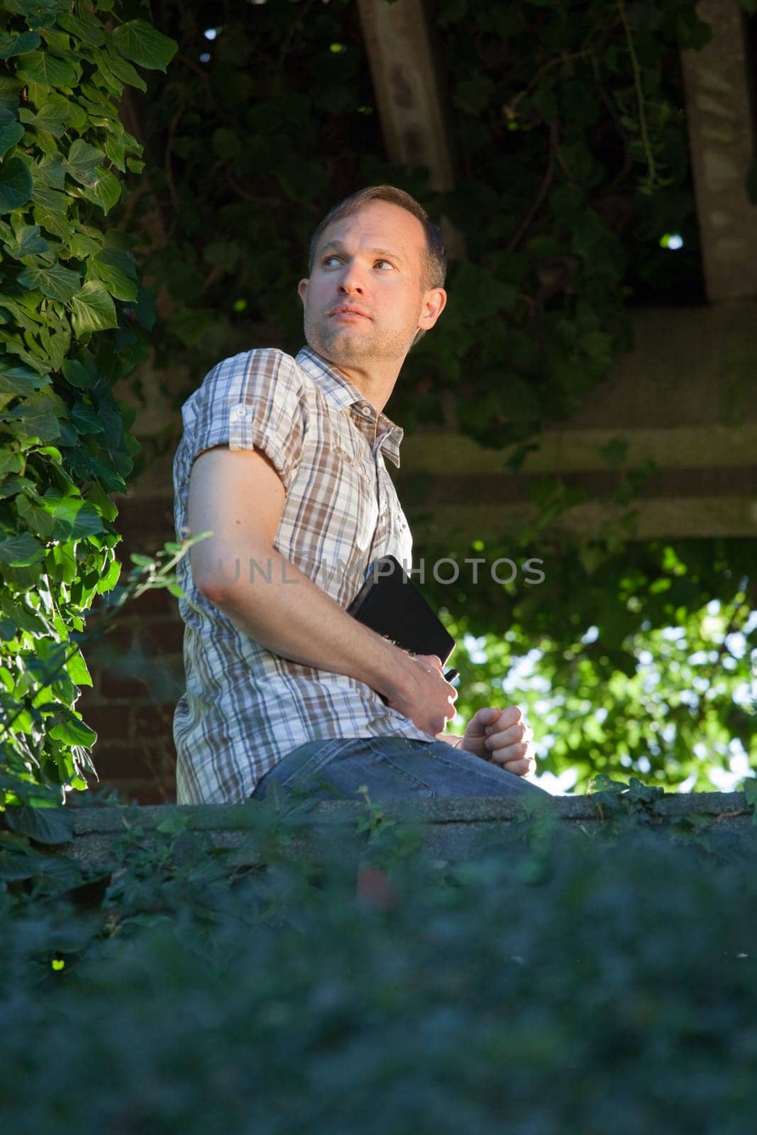 man with diary thinking