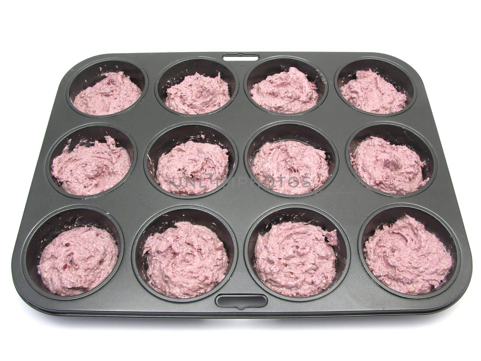 Muffins in the baking pan before baking
