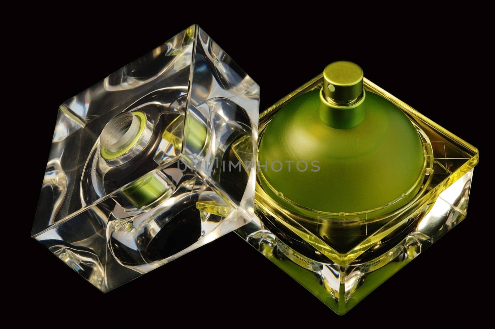 Opened perfume bottle over black