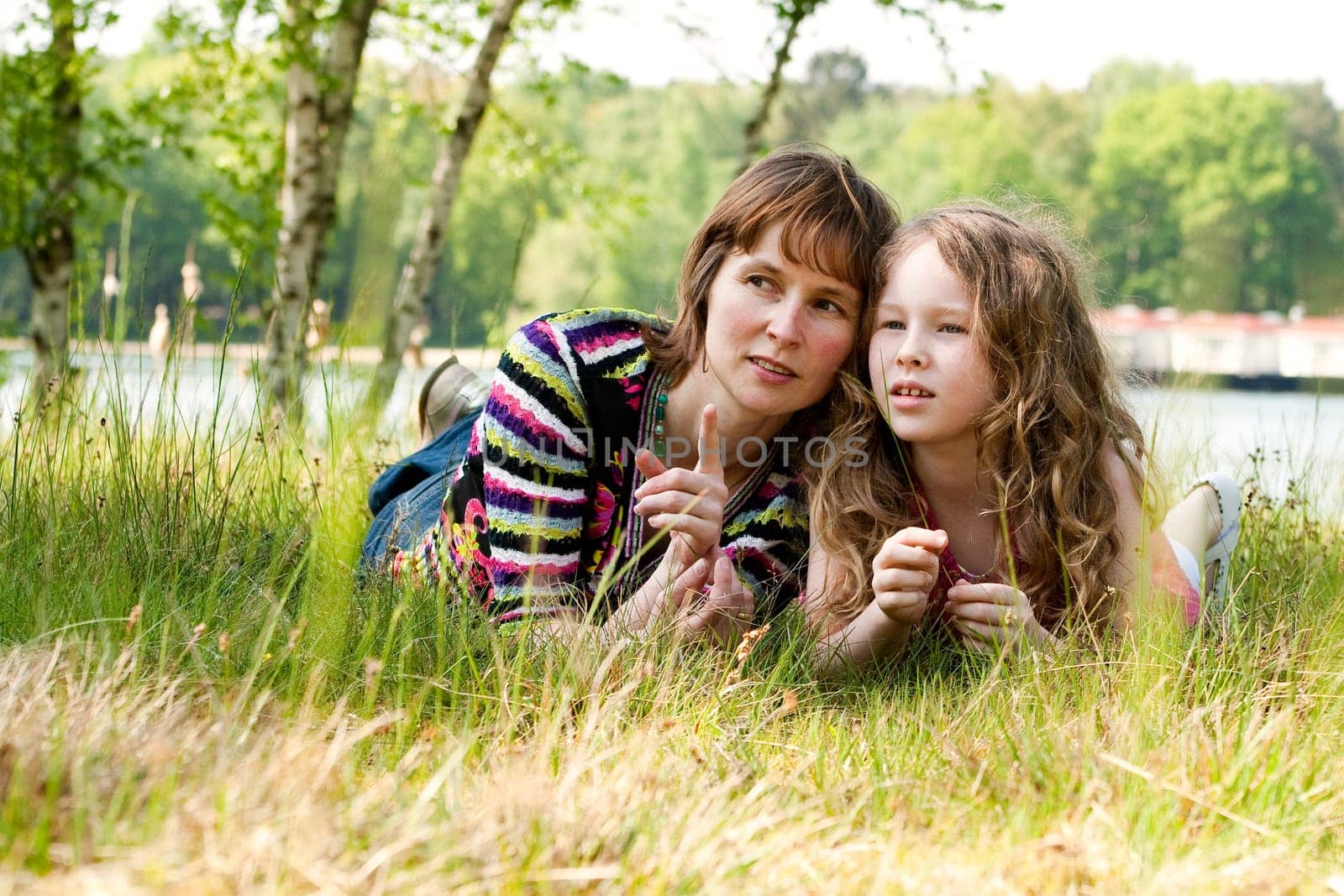 Mother and daugther relaxing in the gras