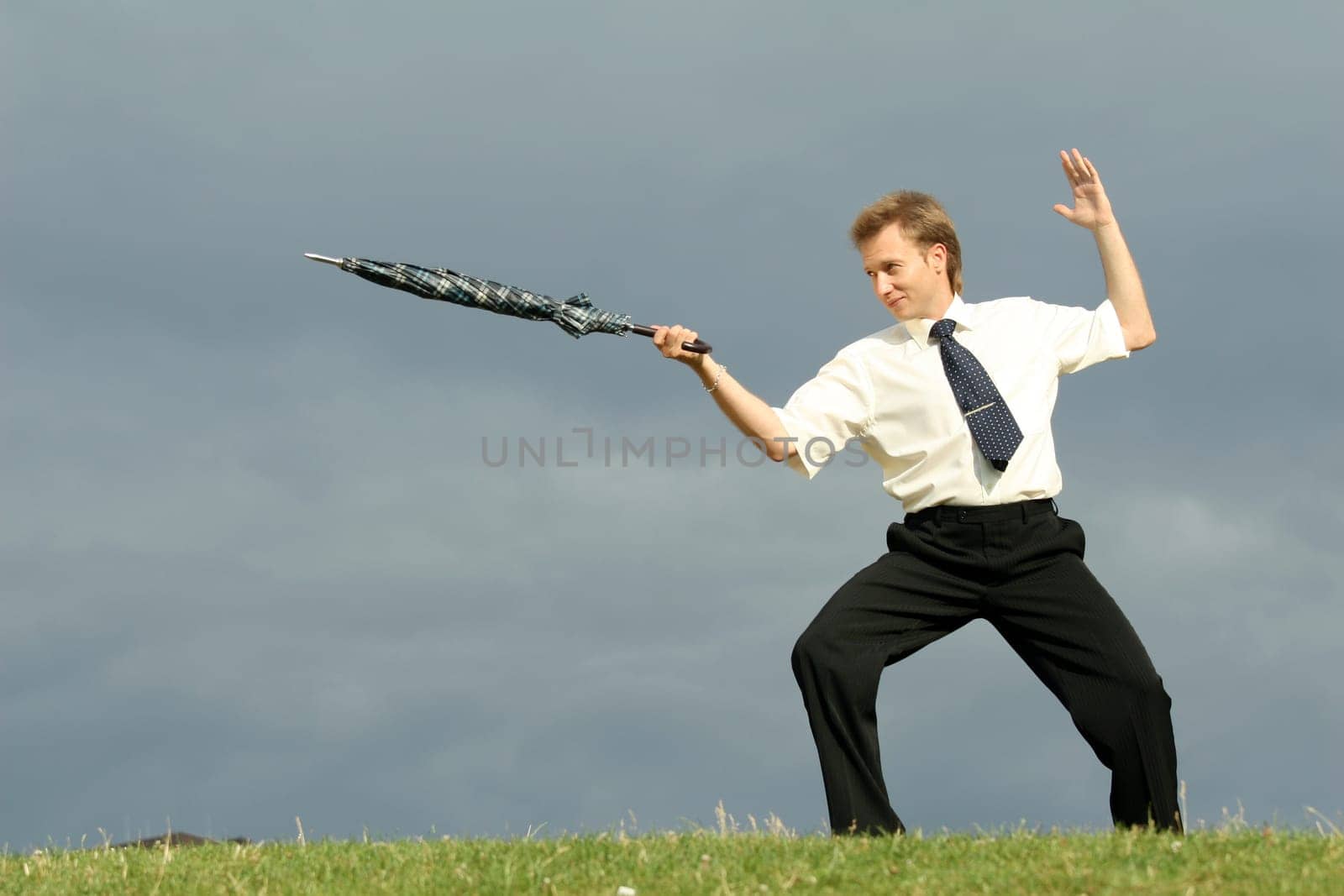 Man fencing with umbrella
