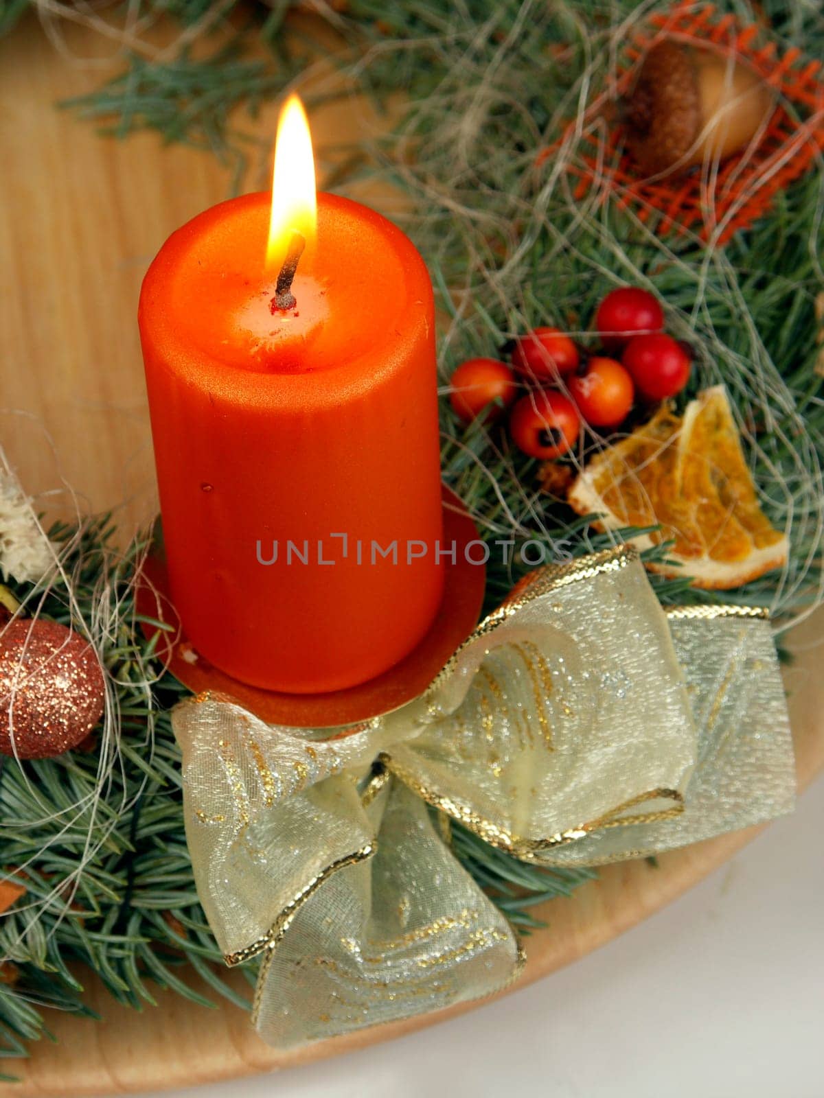 Christmas - wreath from fresh twigs and cones with one candle
