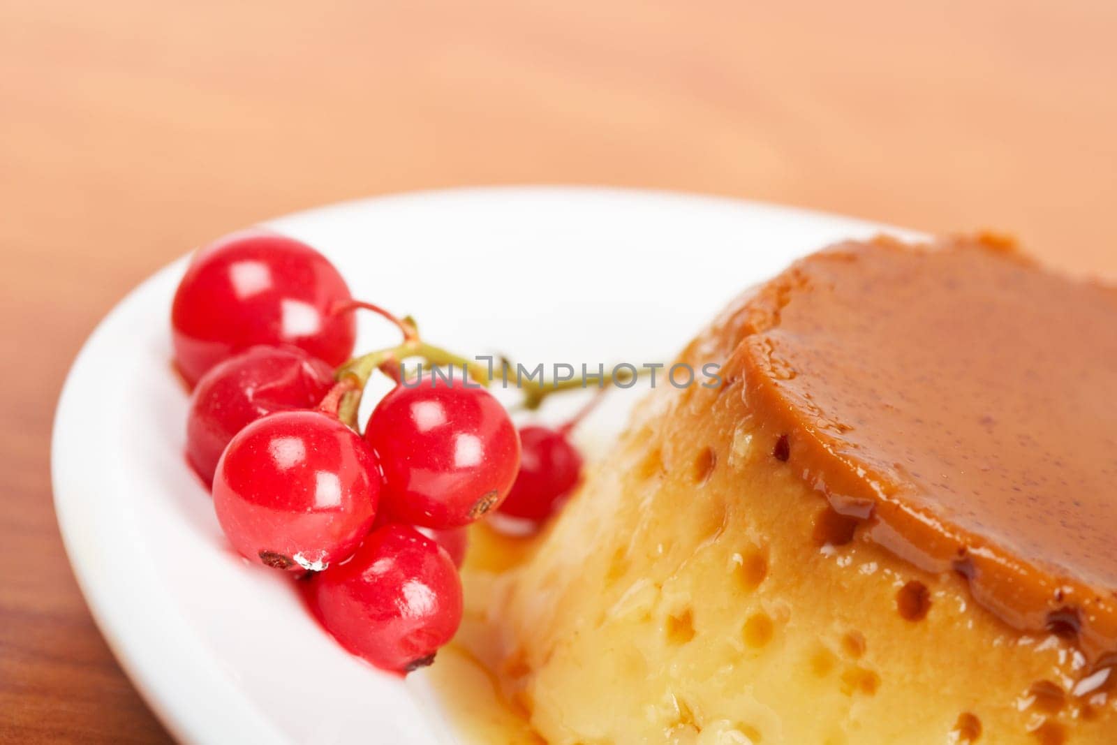 Cream caramel dessert with red currants