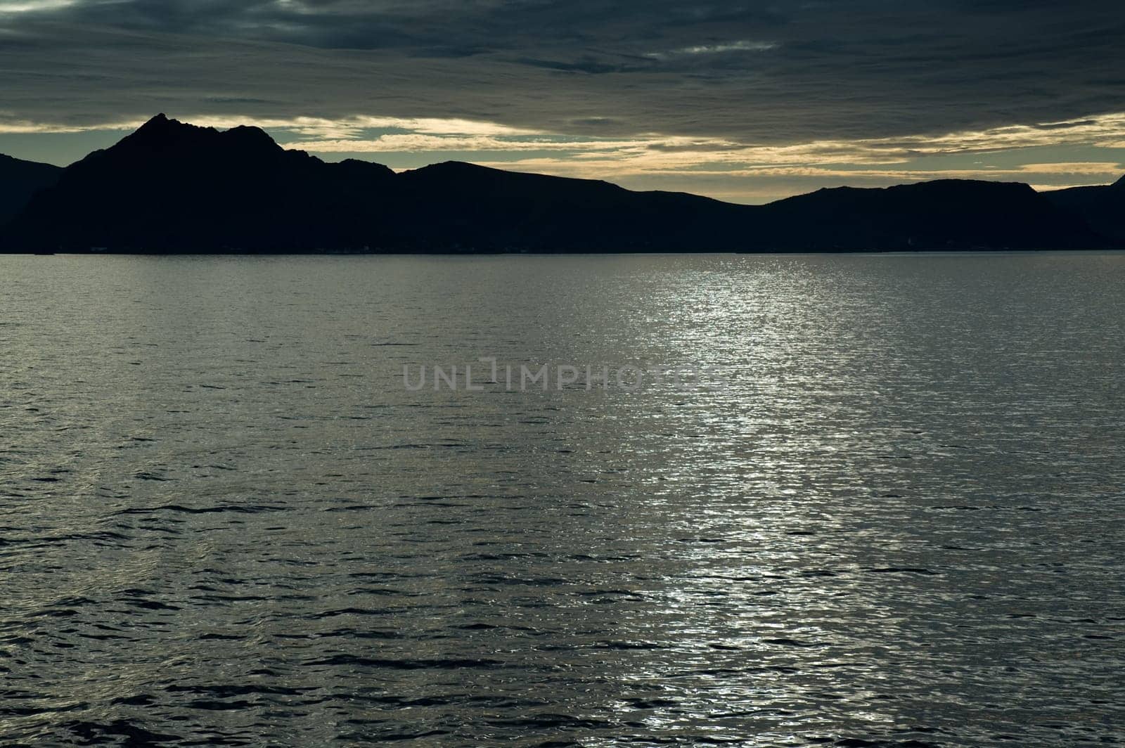 Fjord,backlit mountains