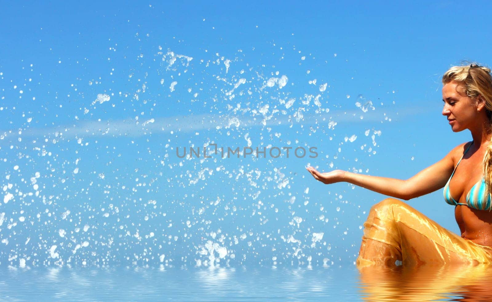 Blonde mermaid with splashes all around