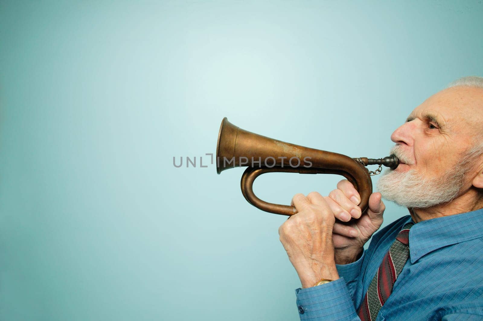 Profile of man playing horn