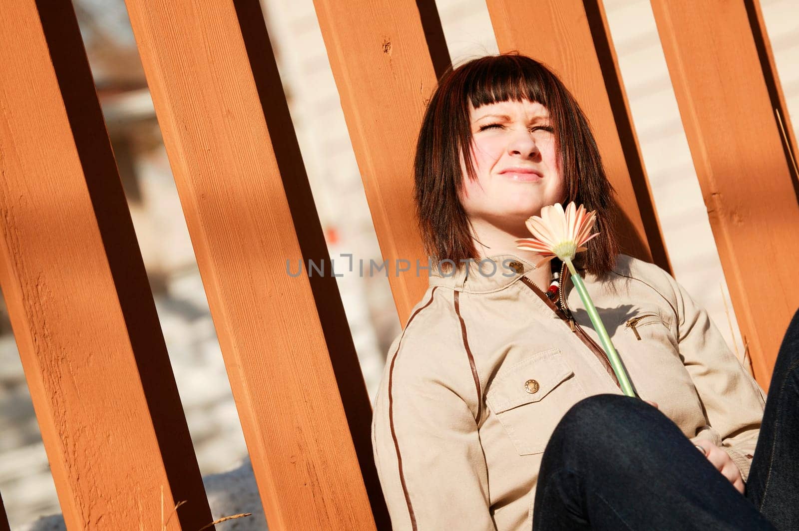 Woman squints at sunlight