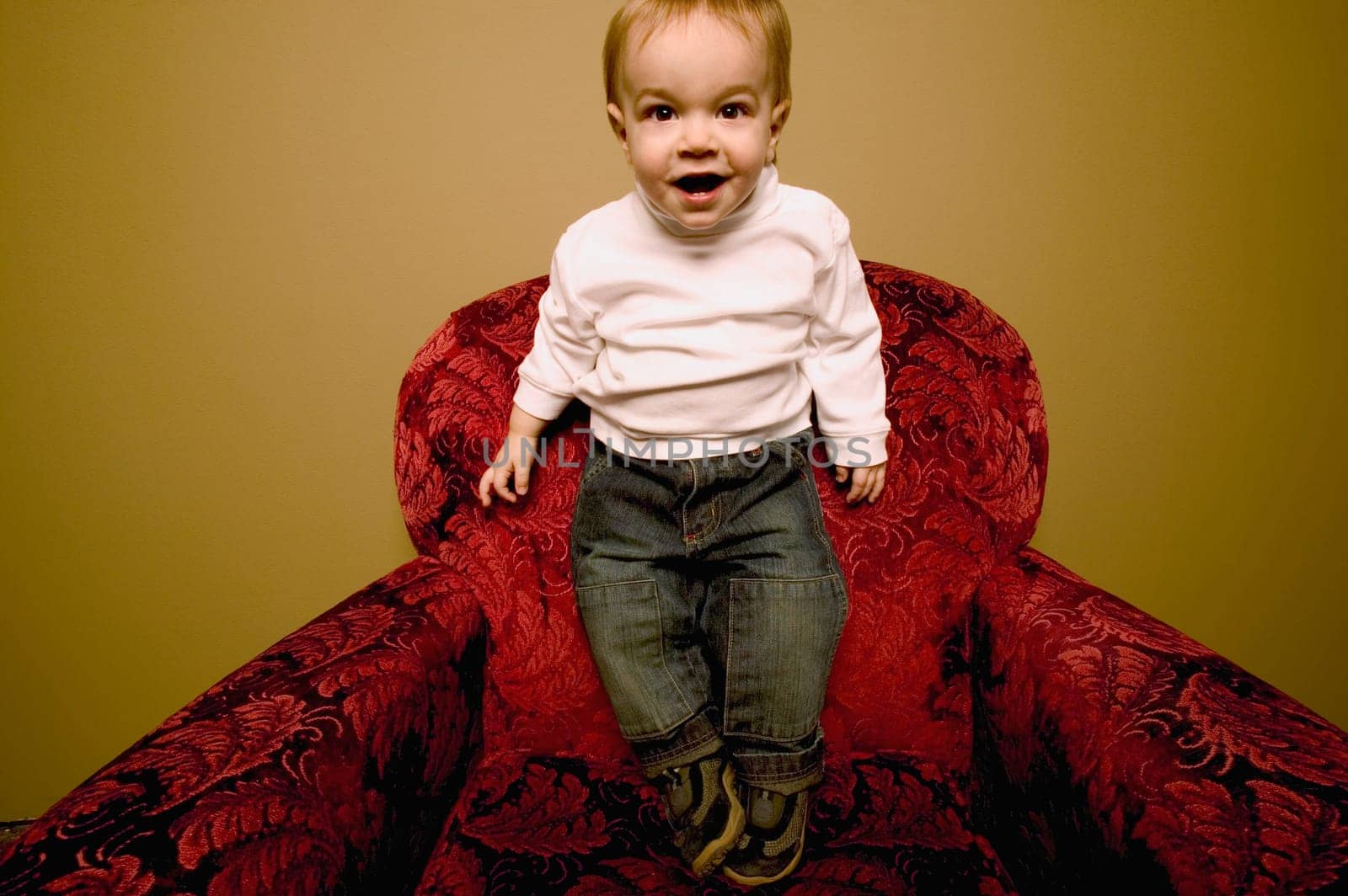 Child stands on chair