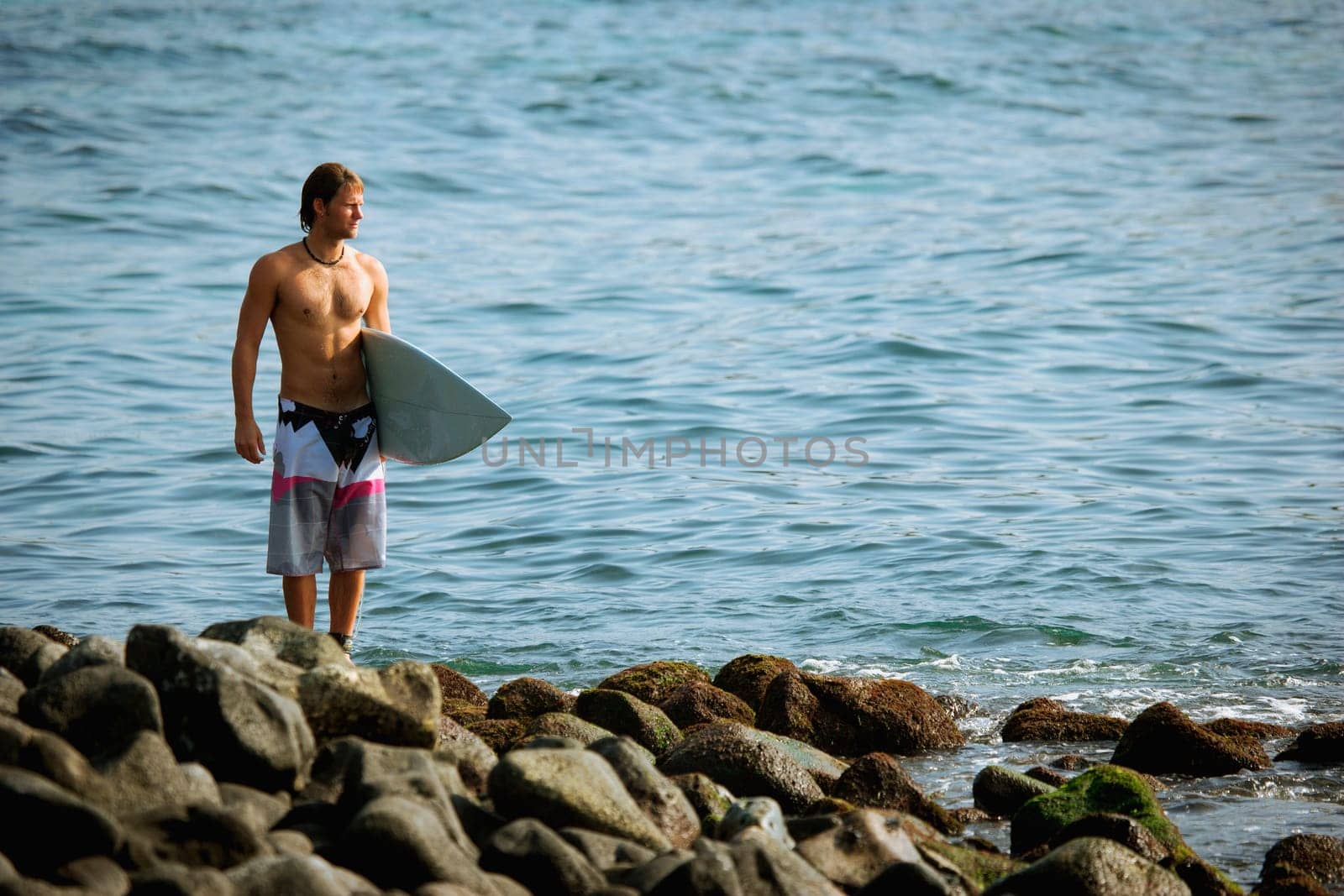 Surfer looking out to sea