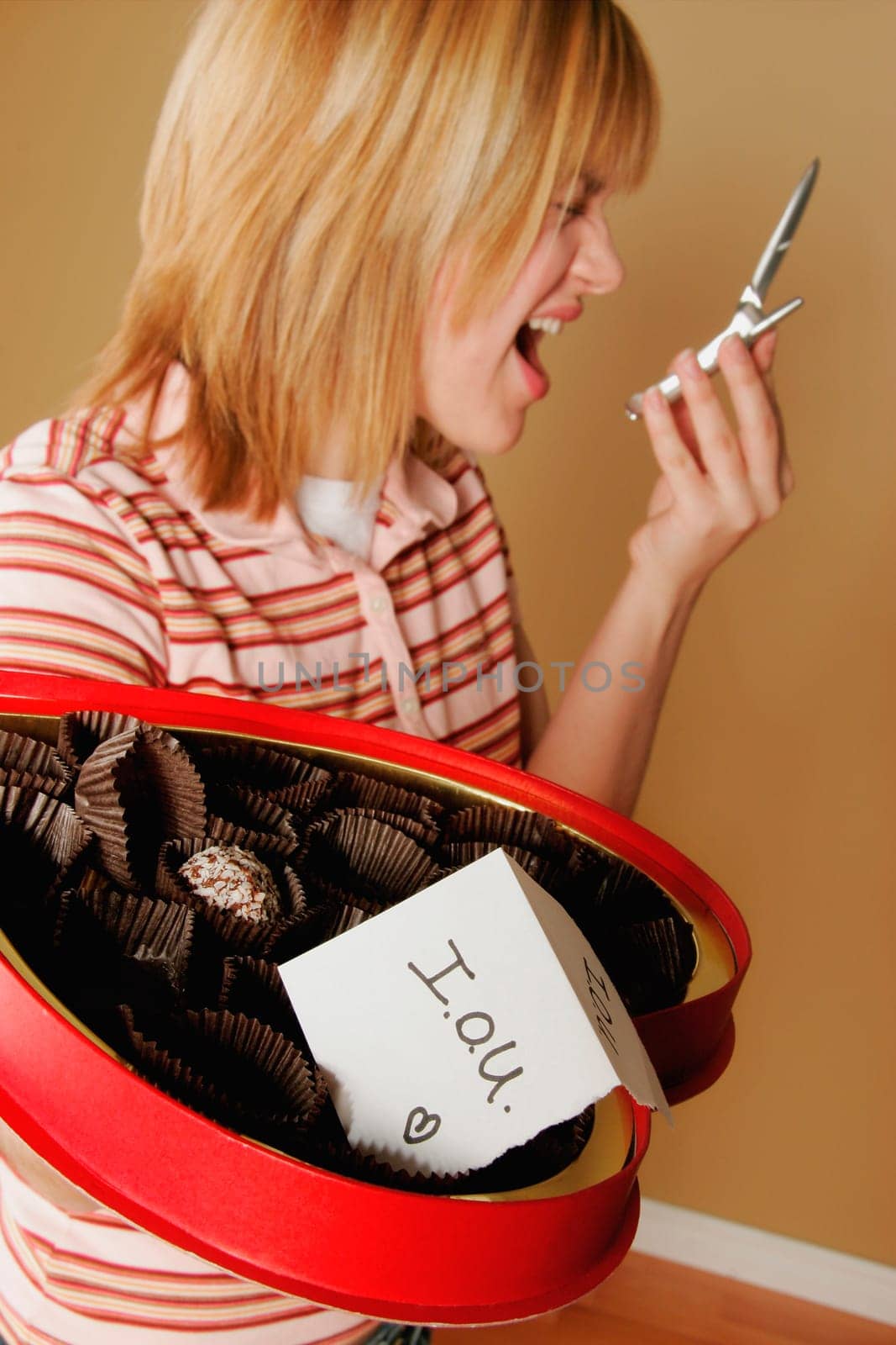 A teenage girl upset over a box of empty chocolates