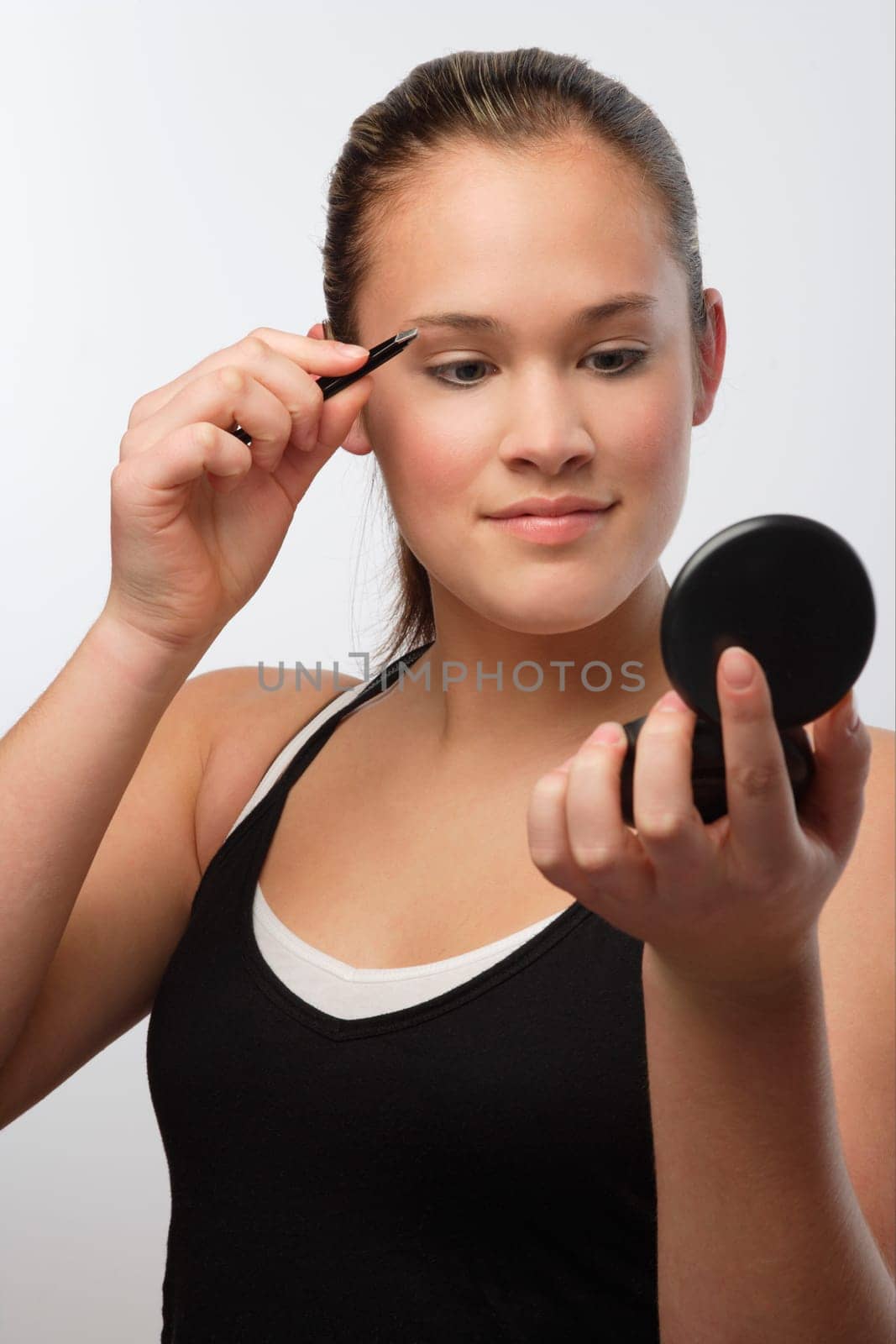 Teenager with compact mirror