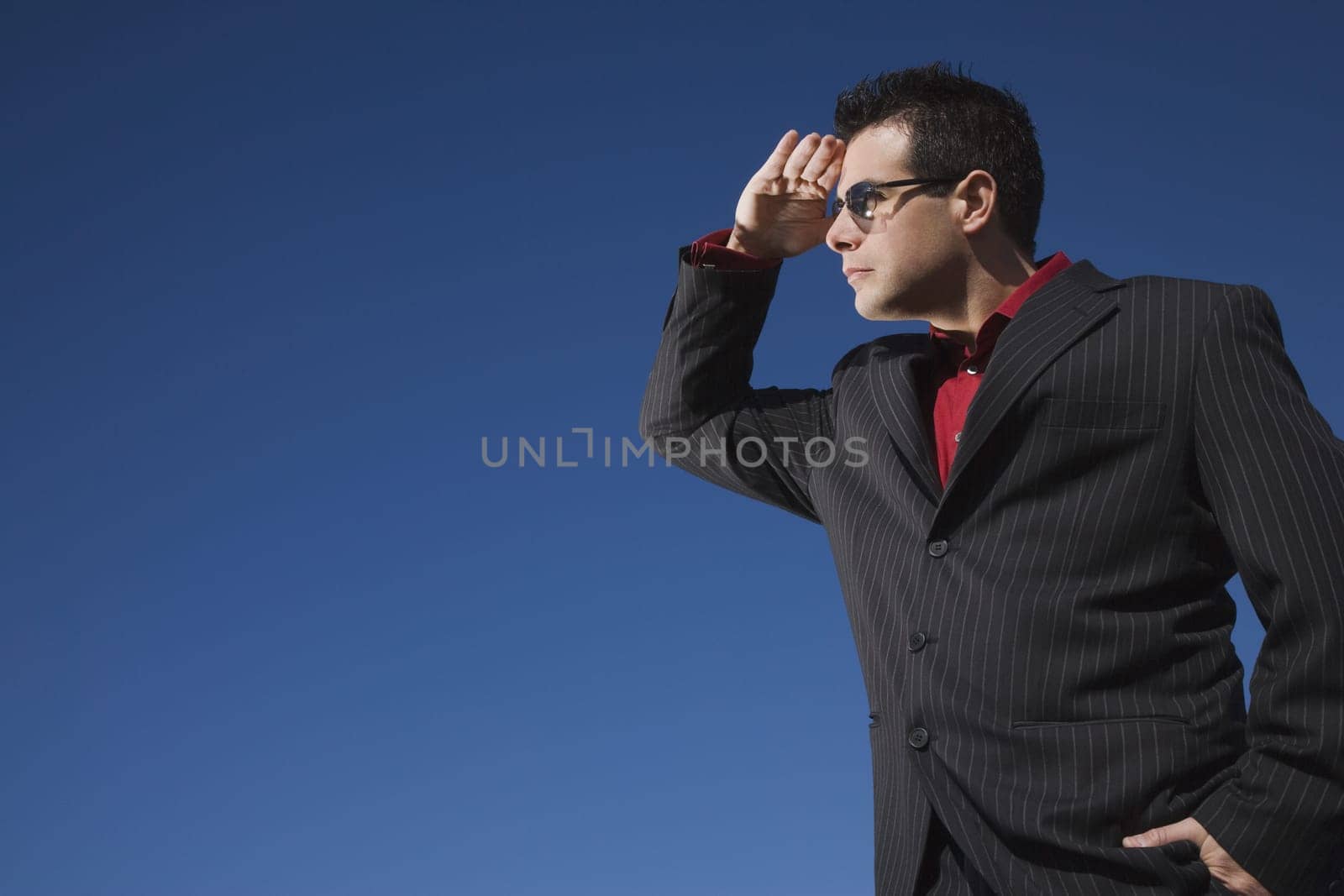 Man in a suit looks into the distance