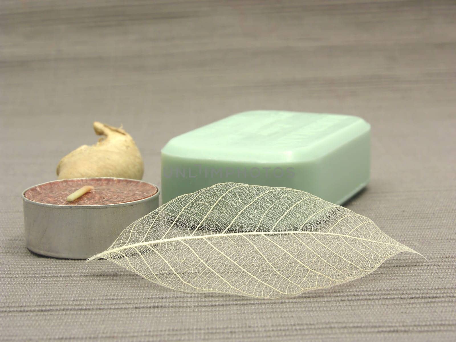 Green soap with decorative items against gray background