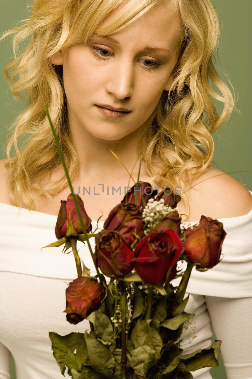 Young woman with withered roses