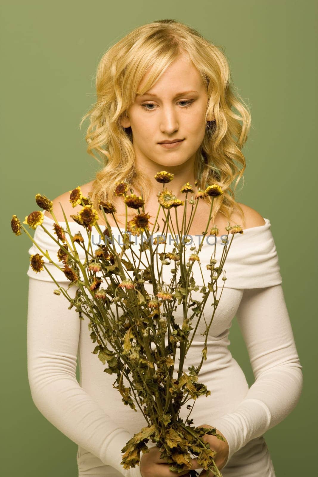 Lady looking at wilted flowers