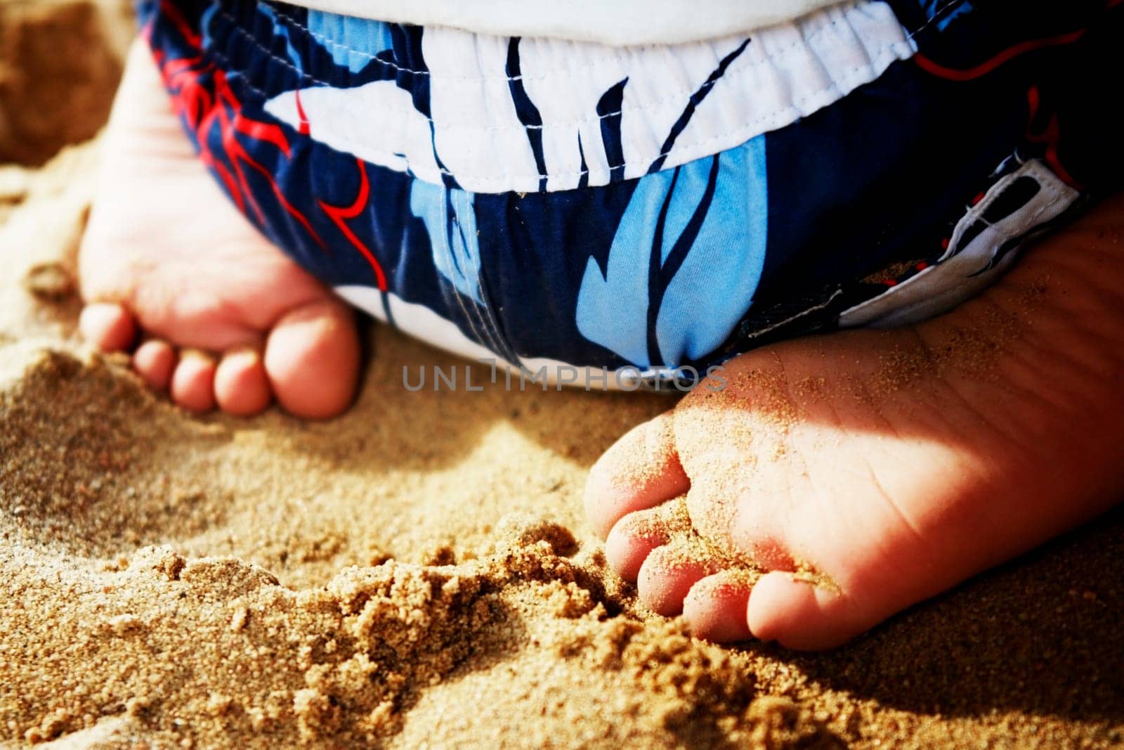 Child sitting in sand