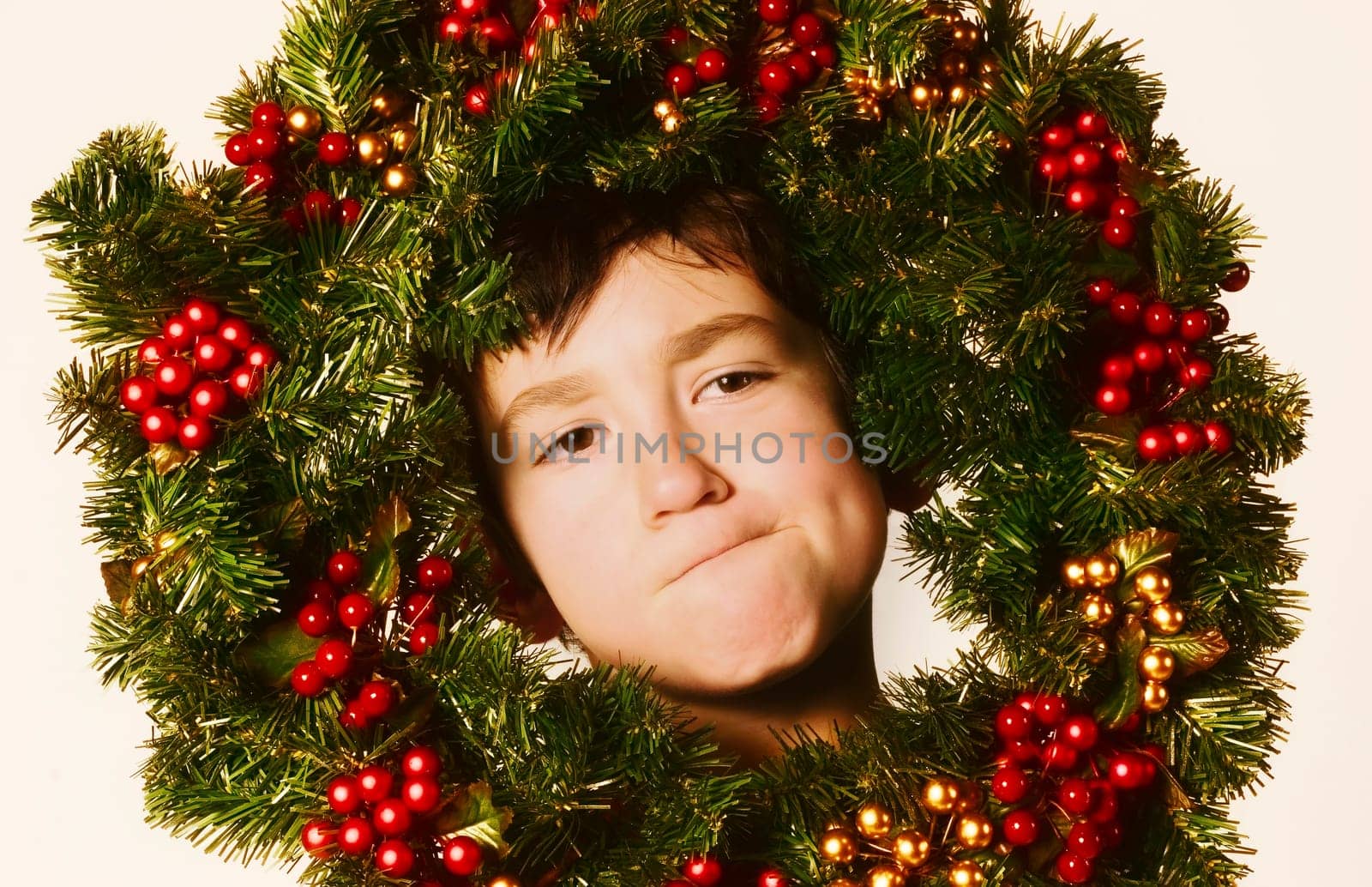 Young boy in Christmas wreath