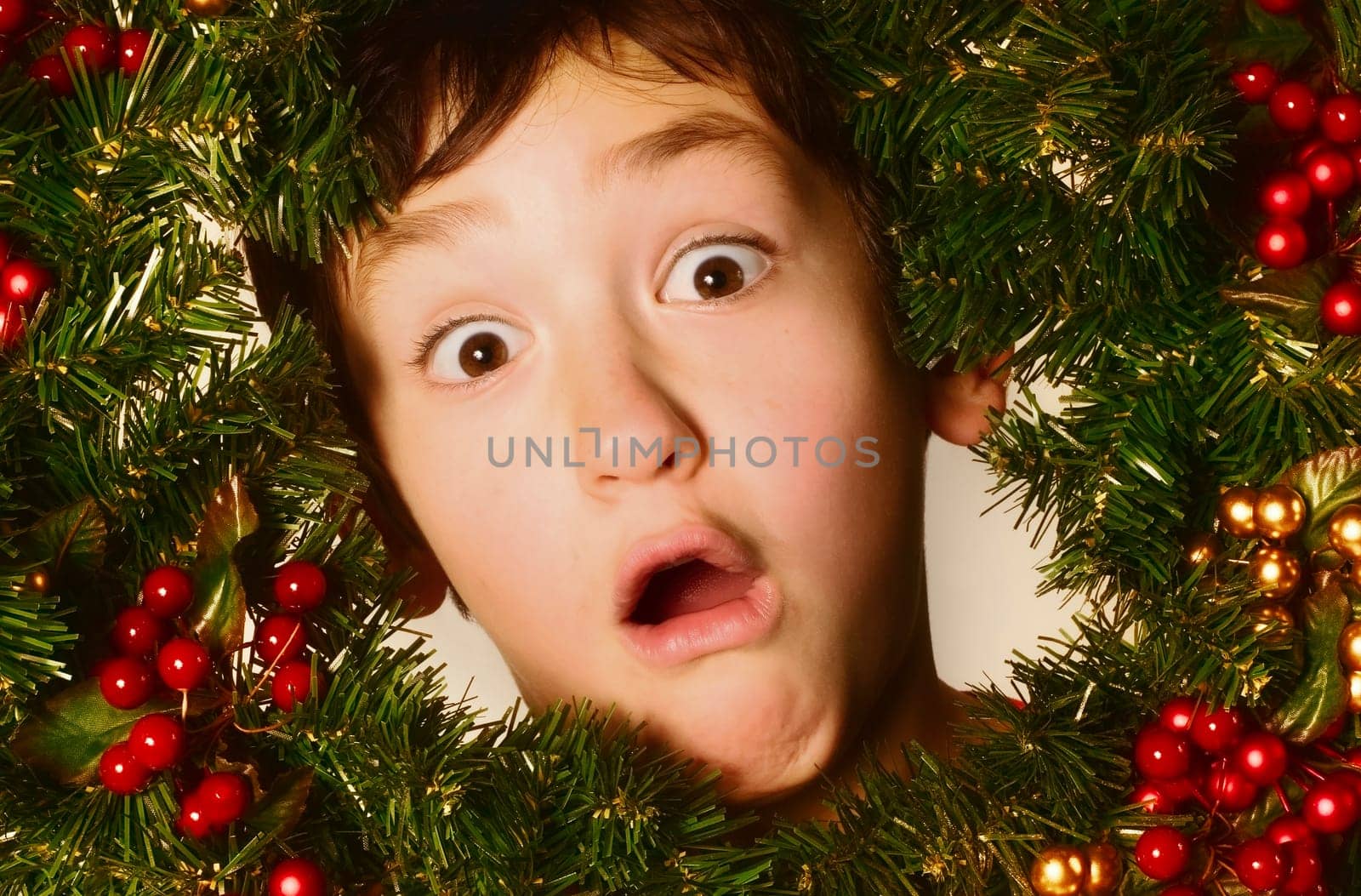 Boy in a Christmas wreath