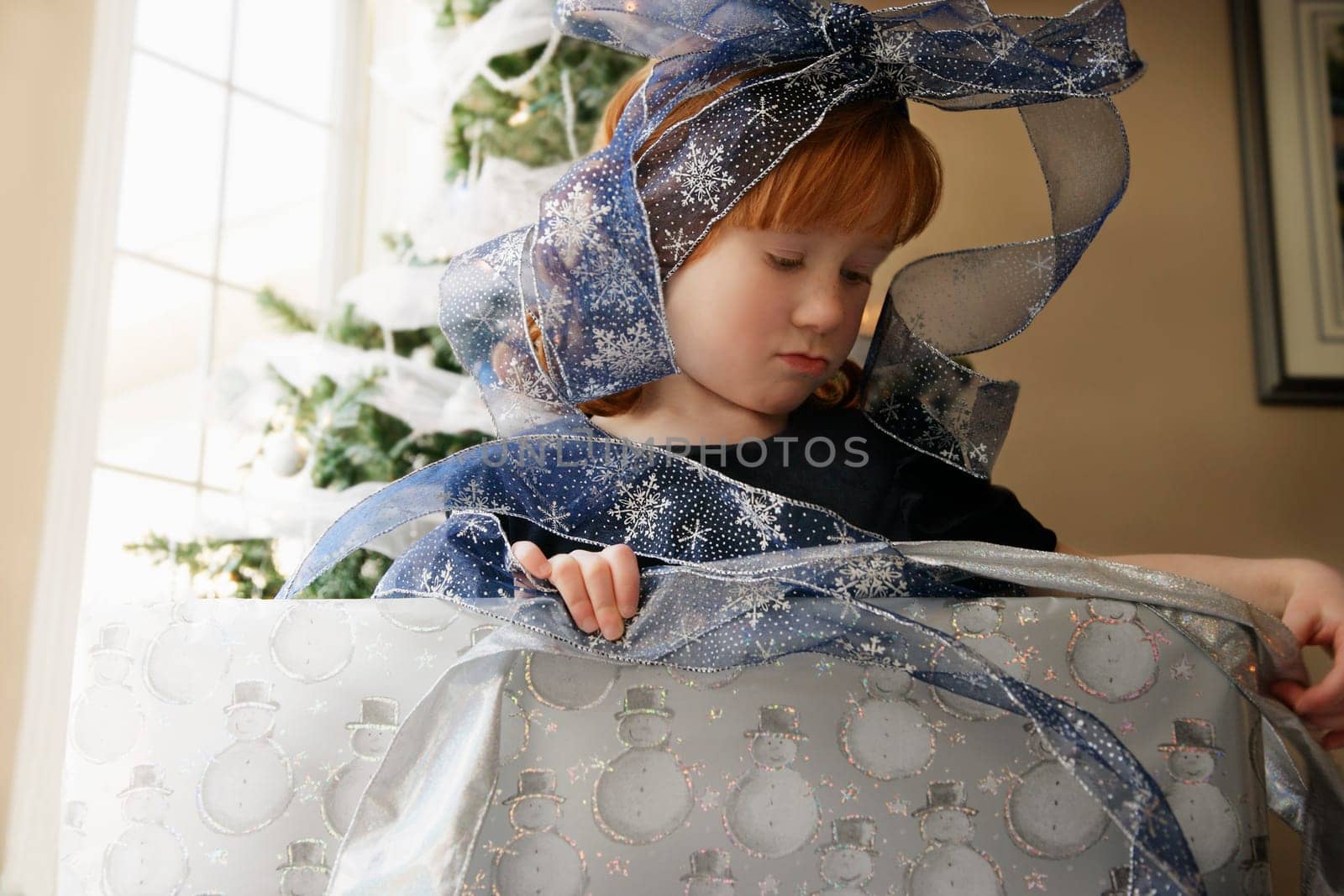 Girl wrapping a Christmas present