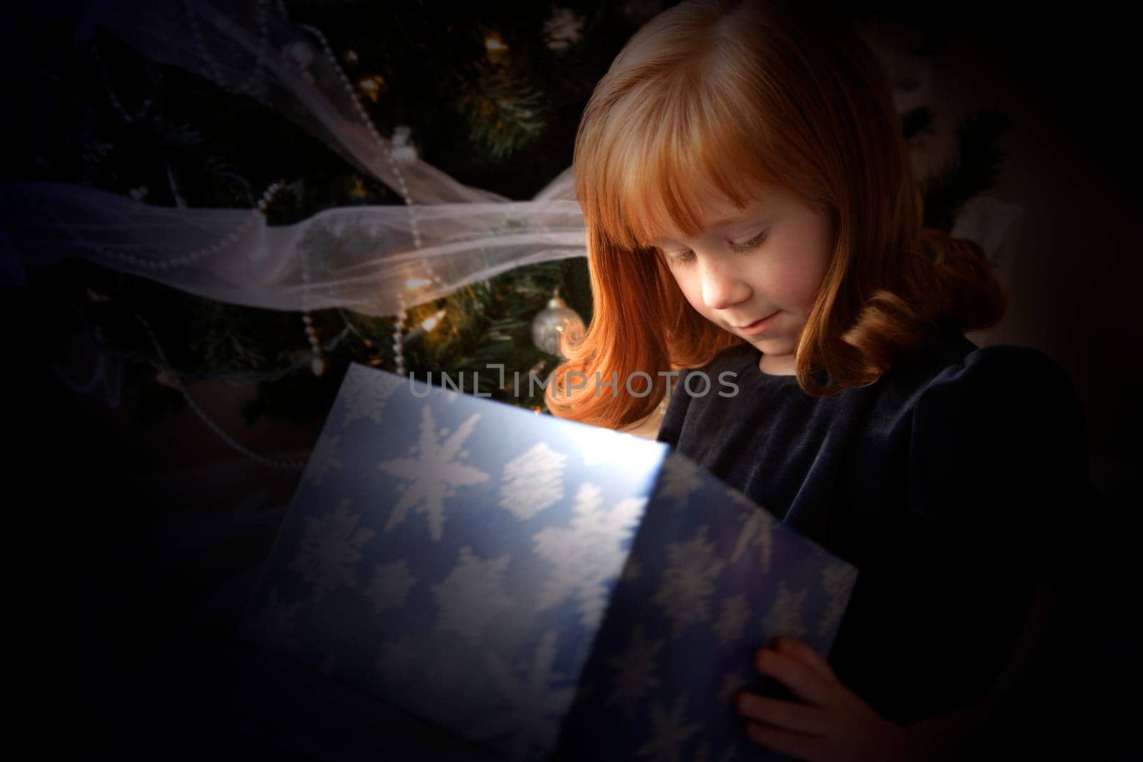 Girl looking inside a Christmas present