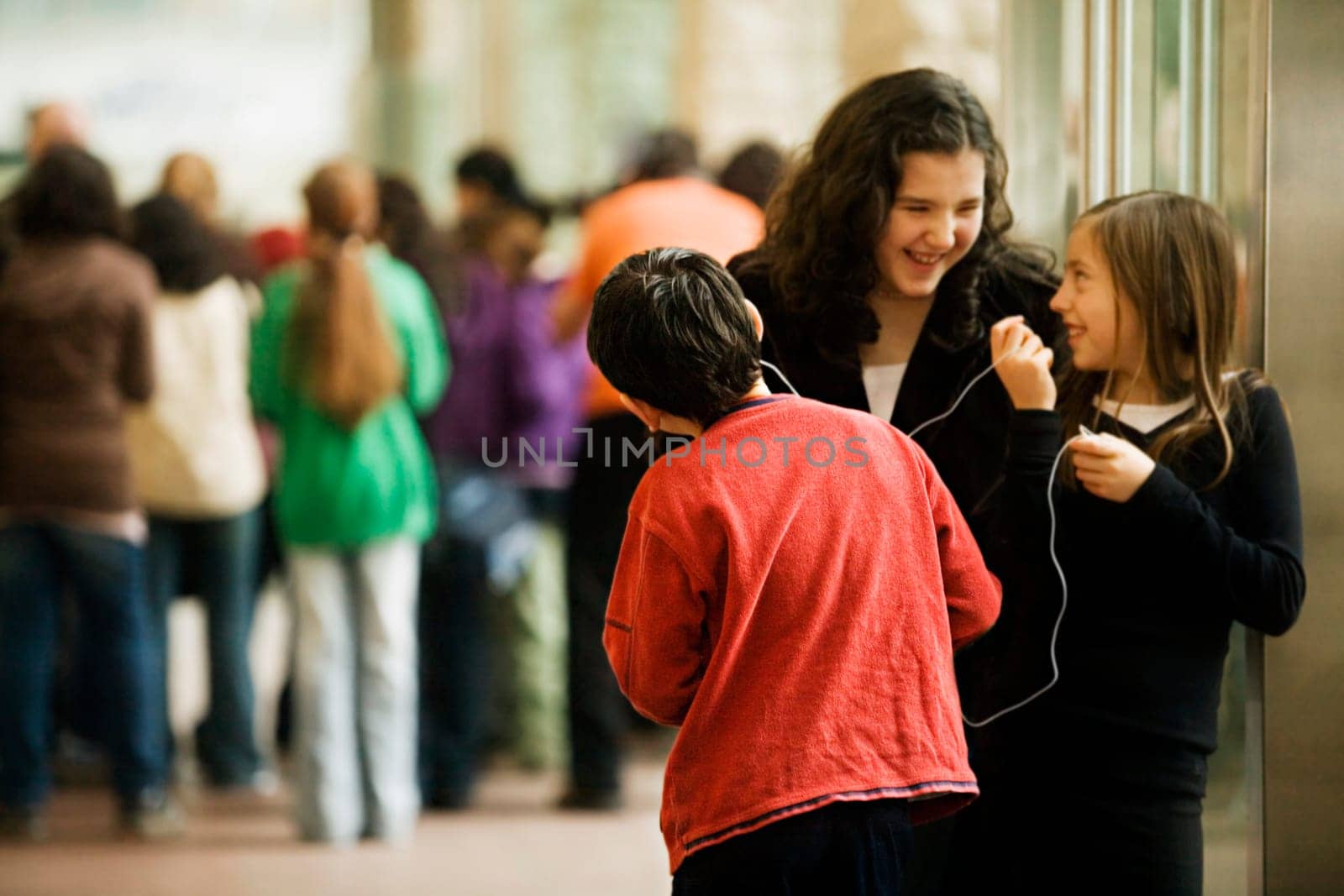 Students listening to music in a school hallway
