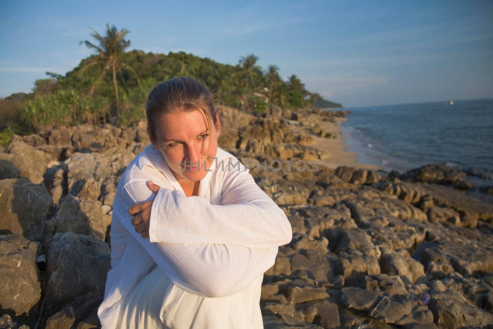 Woman on rocky shoreline