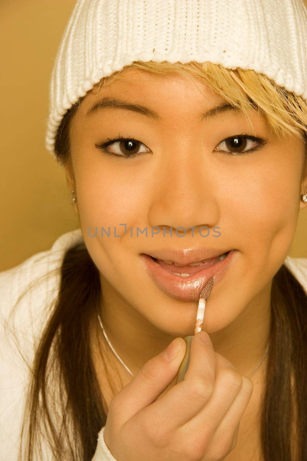 Woman applying lip gloss