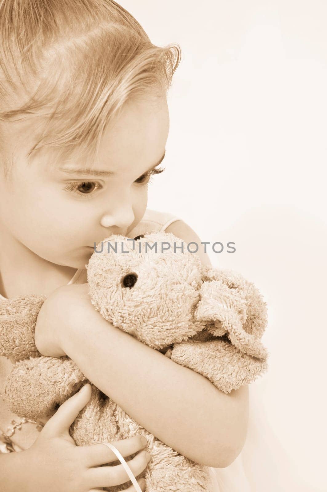 Girl kissing her stuffed animal