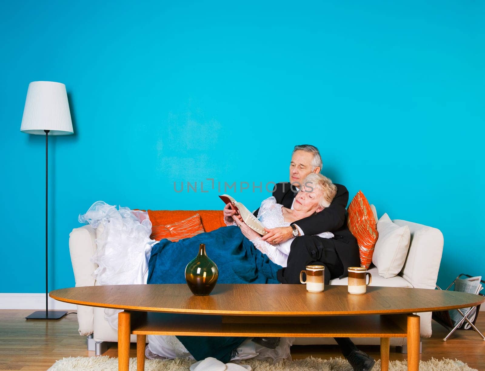 Senior couple reading on the couch together