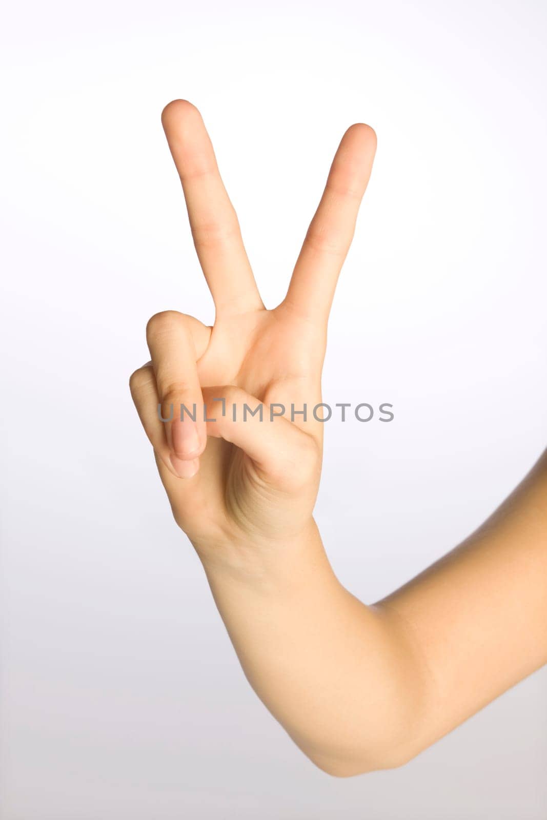 Woman's hand making a peace sign