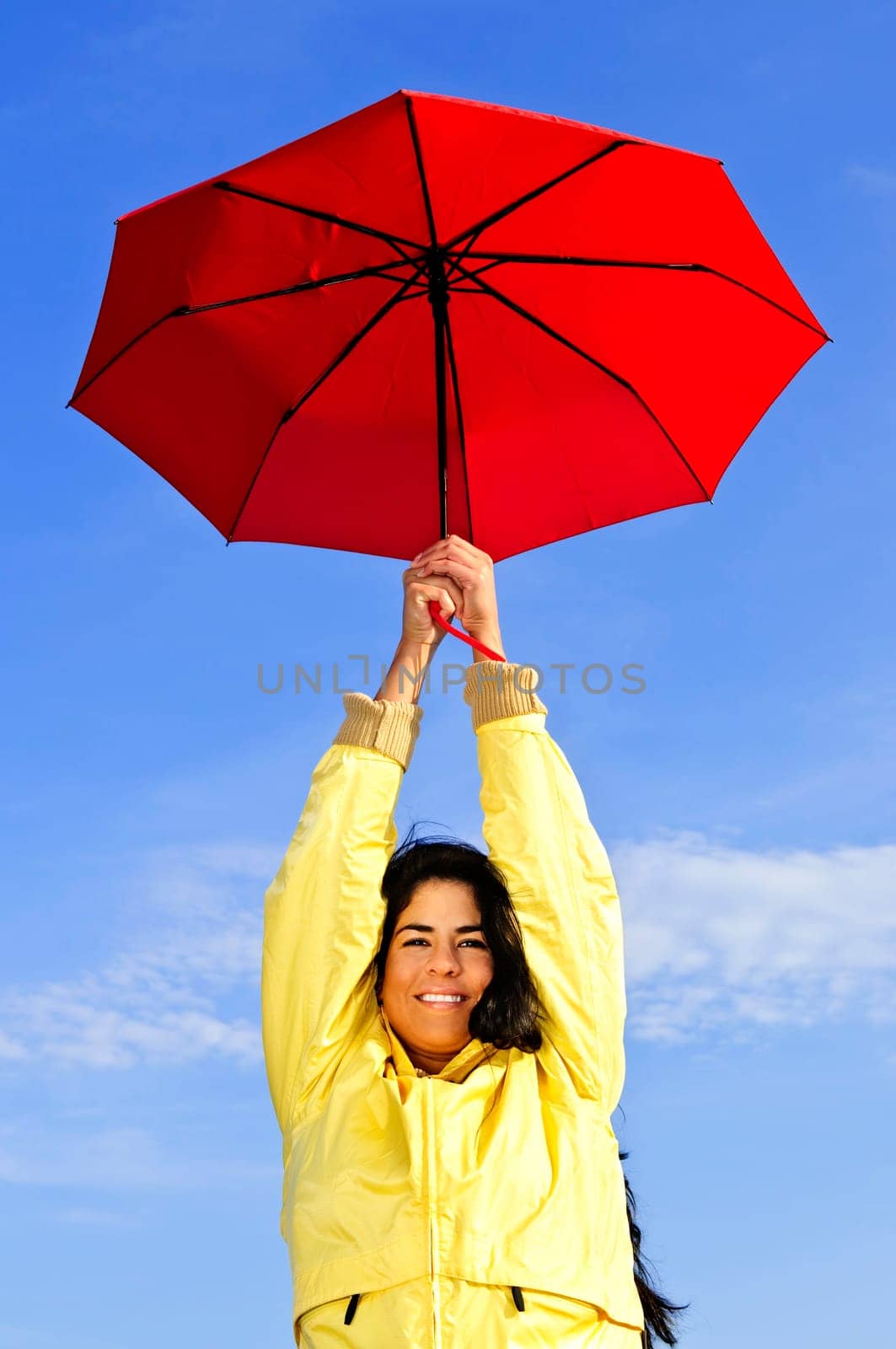 Beautiful young woman in raincoat with u