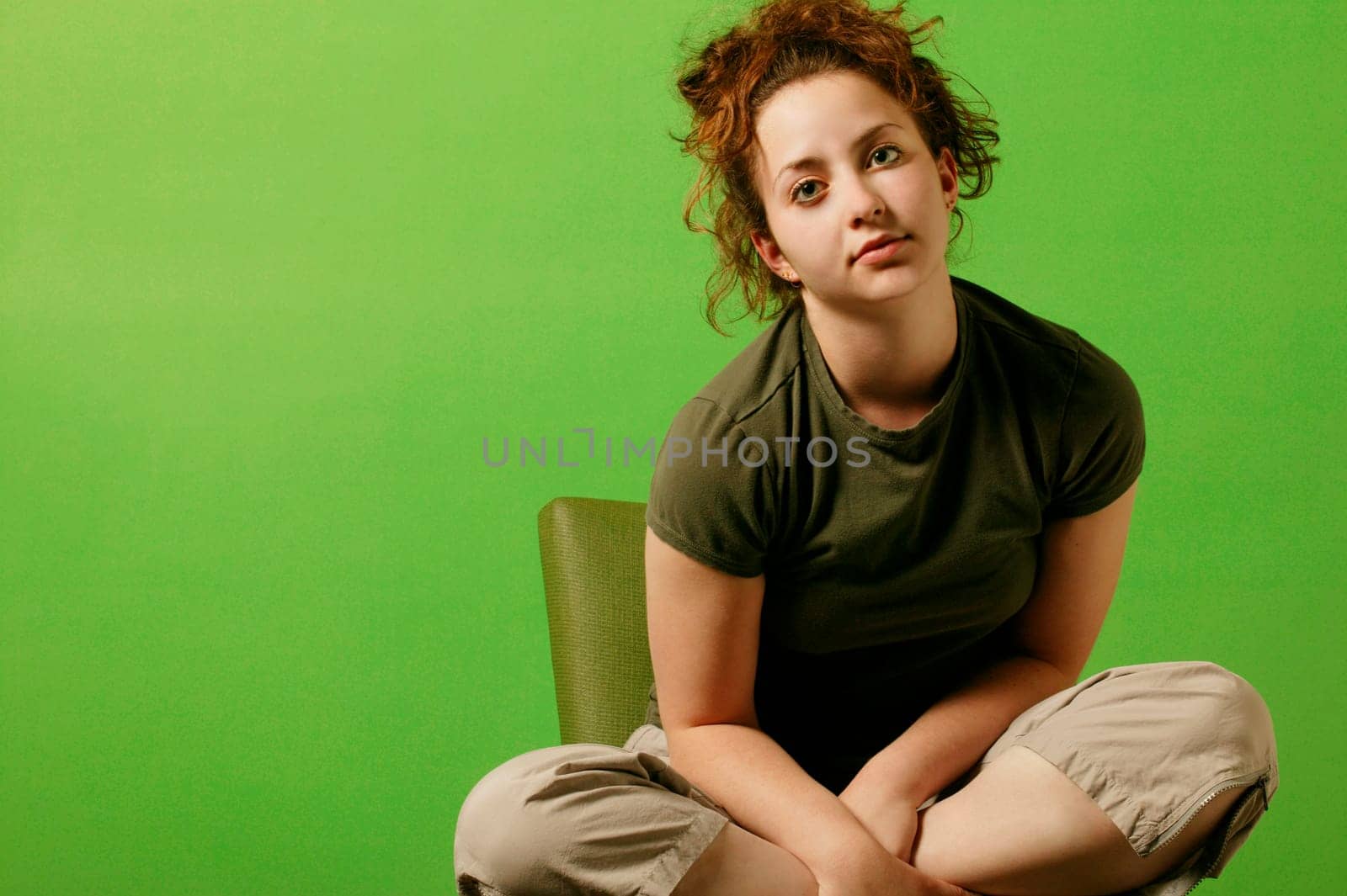Teenage girl sits in a chair