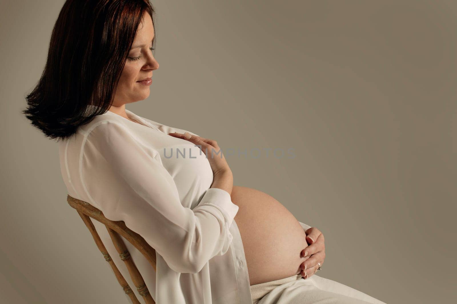 A mother looks at her pregnant belly