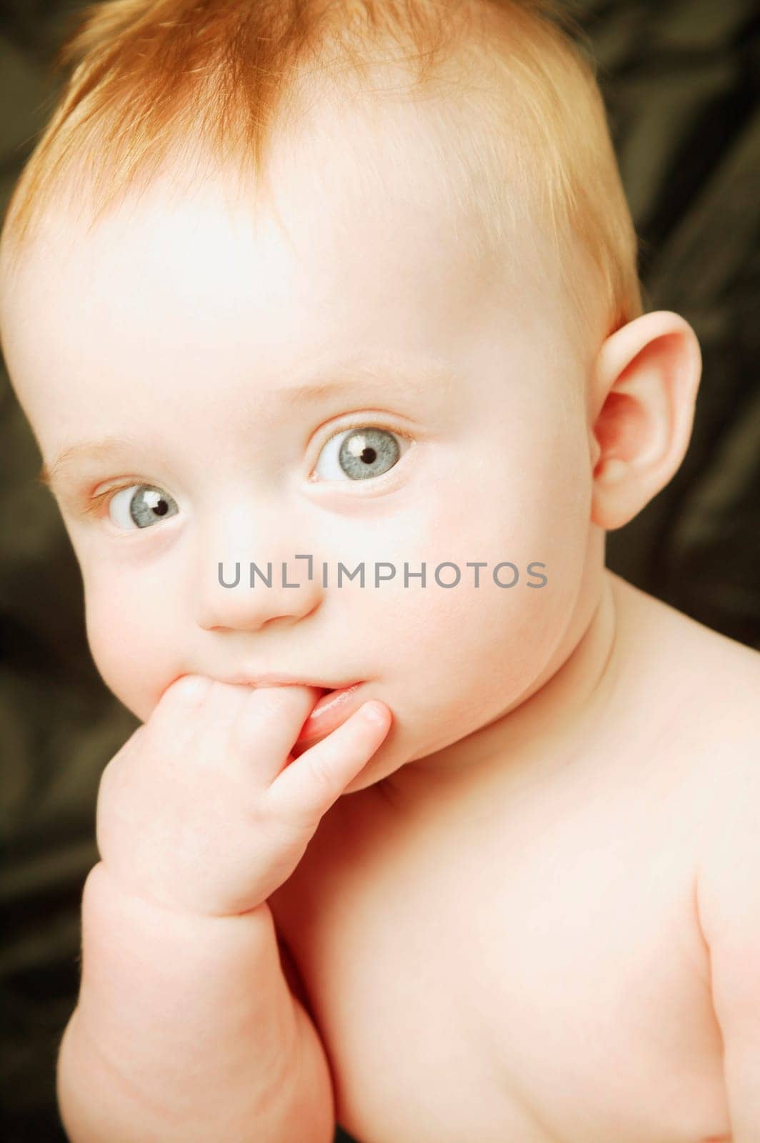 Baby chews on fingers