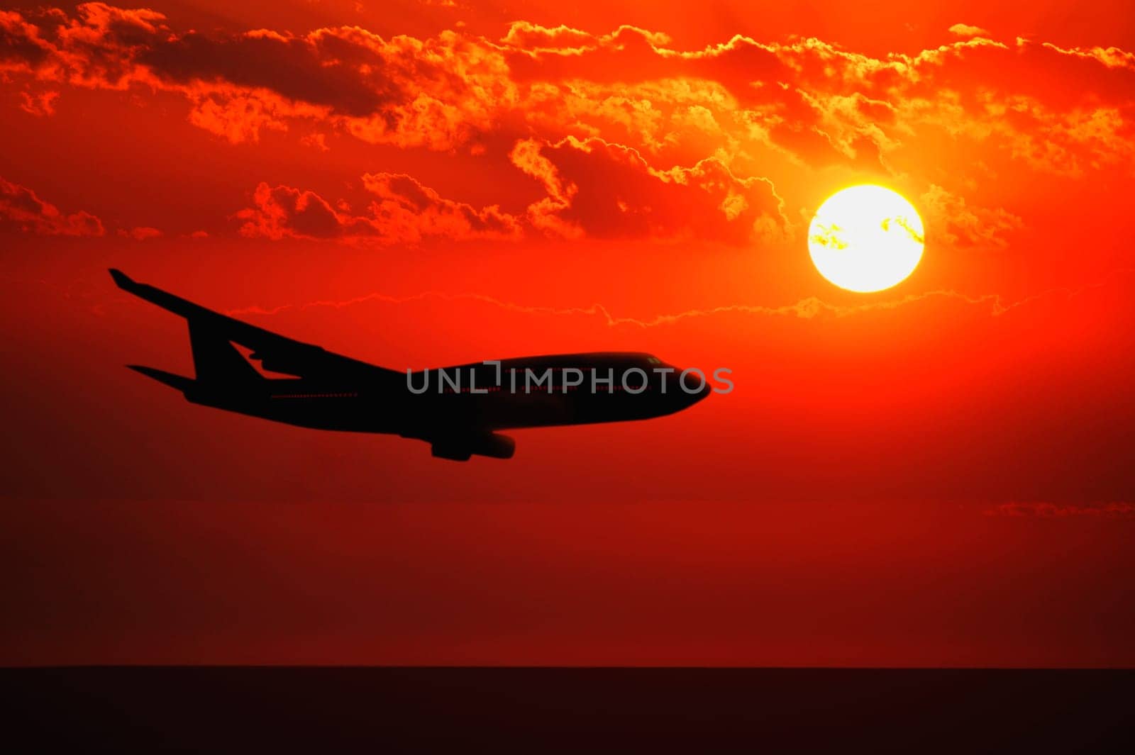Airplane flying during sunrise/sunset