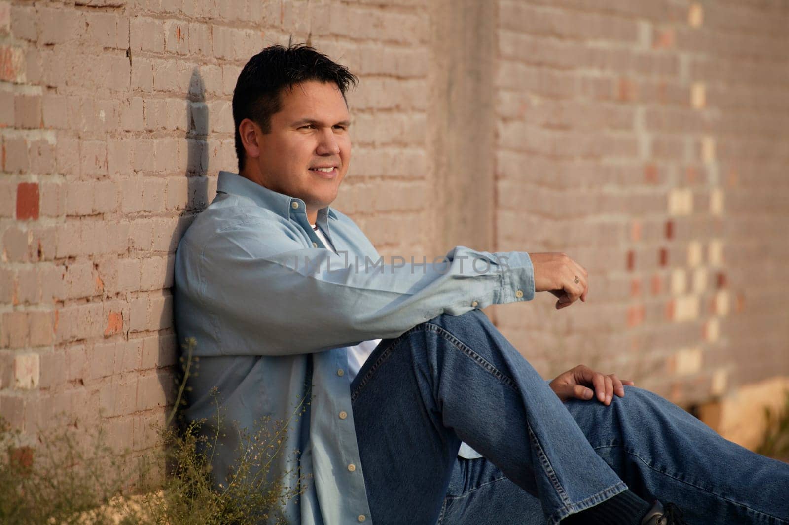 Man leans against wall